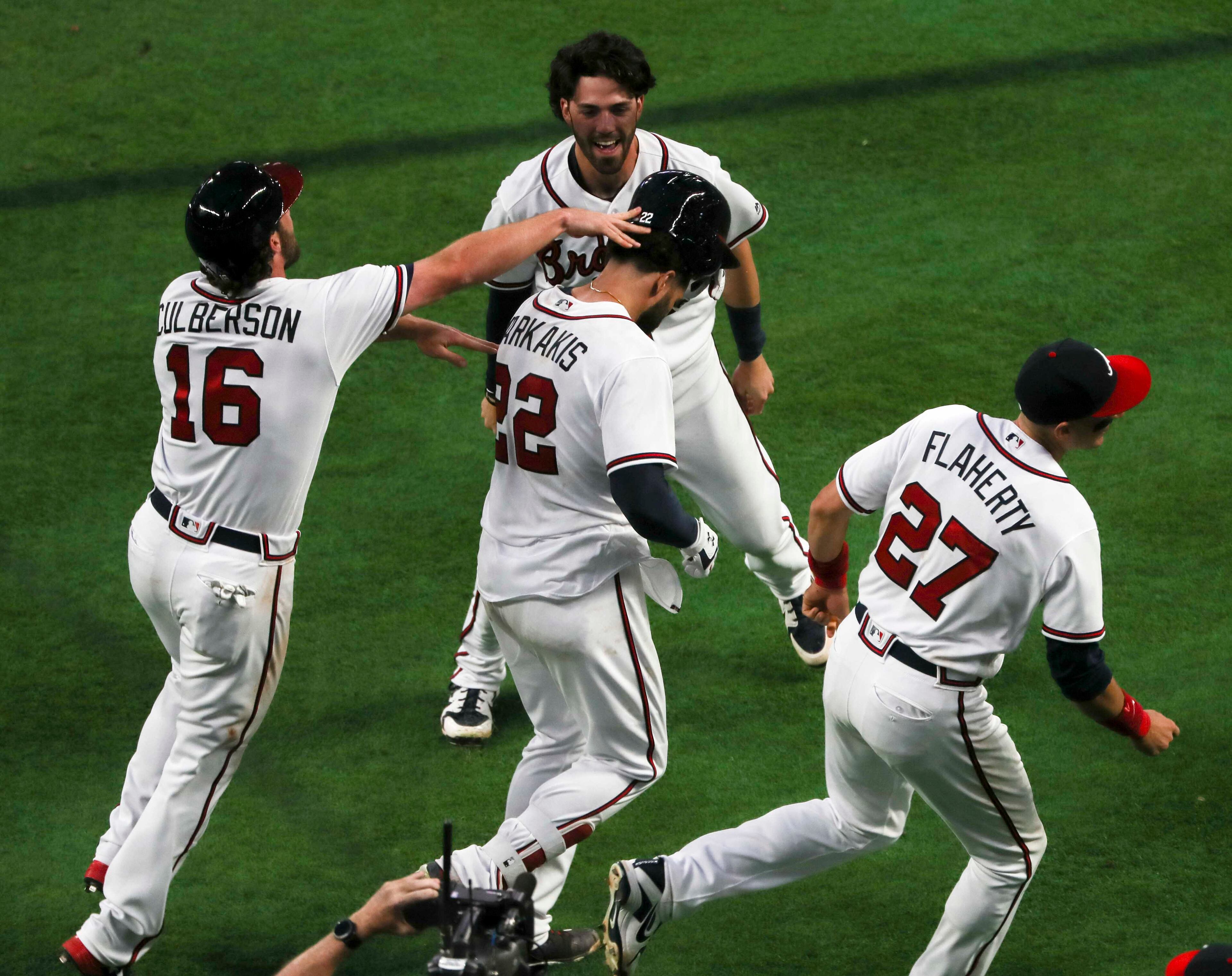 03/29/2018 -- Atlanta, GA - The Braves congratulate Nick Markakis (22) after he hit a home run securing the Braves season opener victory over the Philadelphia Phillies at SunTrust Park, Thursday, March 29, 2018. The Braves beat the Phillies, 8-5. ALYSSA POINTER/ALYSSA.POINTER@AJC.COM