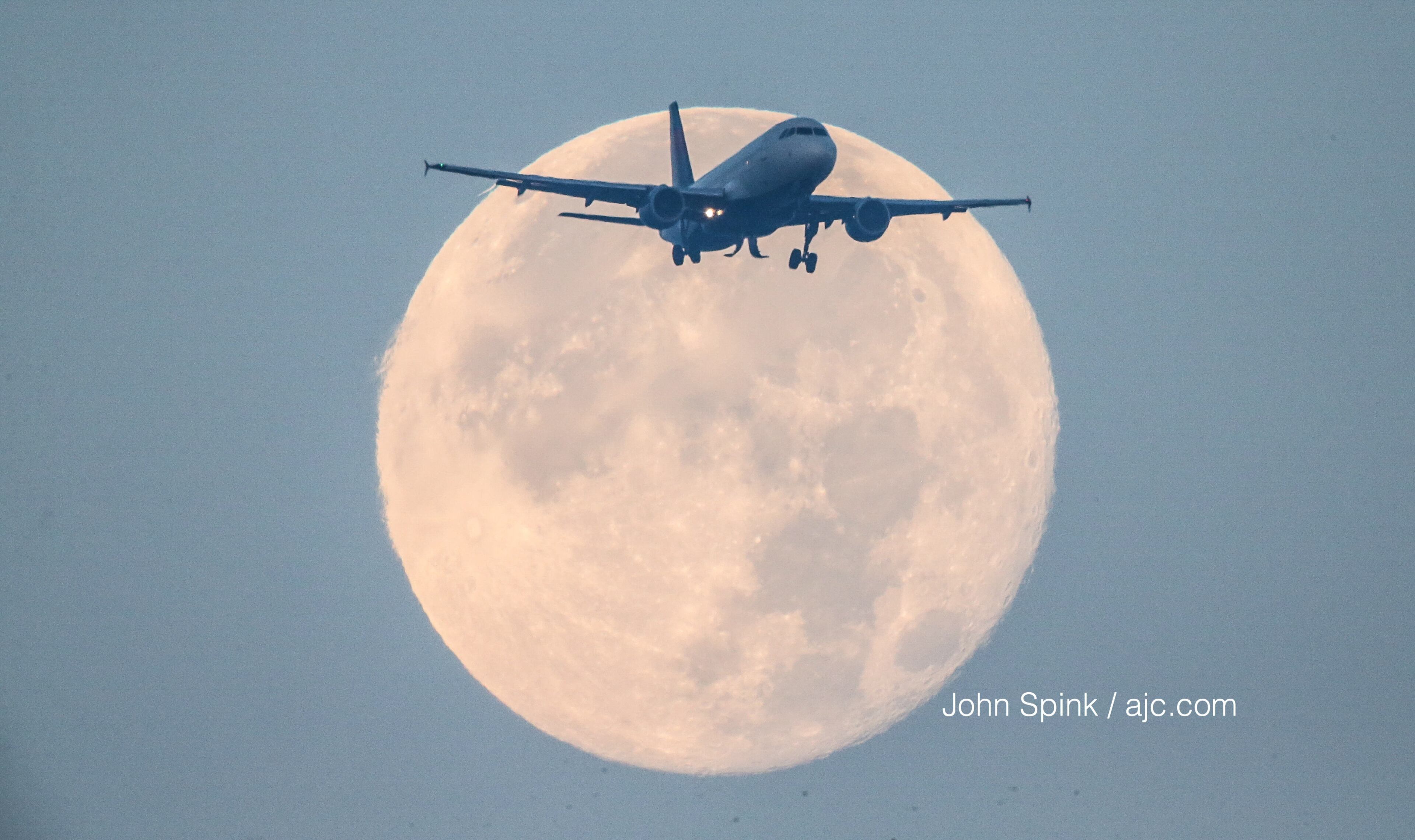 A supermoon frames a flight into Atlanta's Hartsfield-Jackson Atlanta International Airport on Sunday, Dec. 3, 2017.