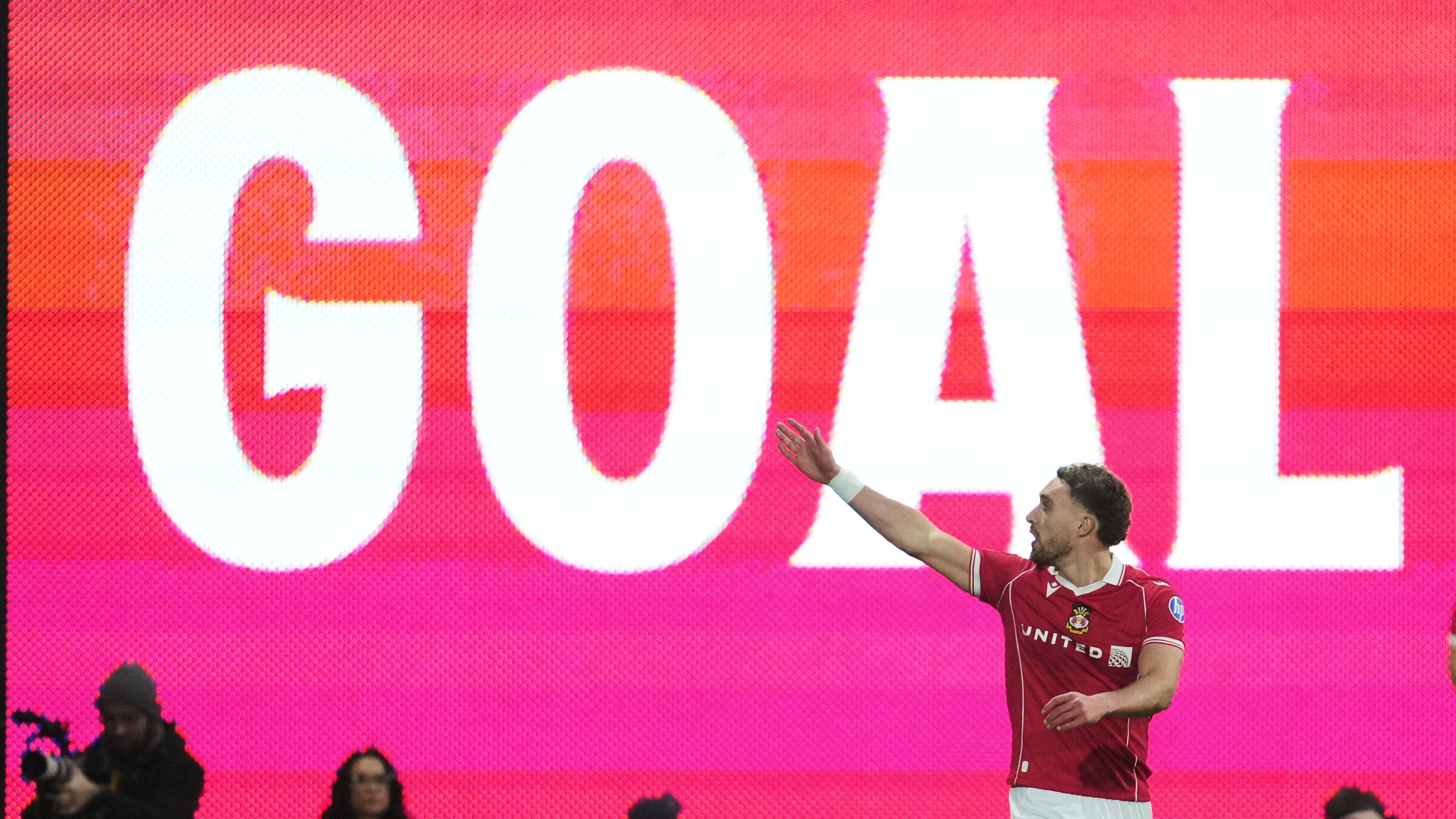Wrexham's Sam Smith celebrates after scoring during the fifth round FA Cup soccer match between Wrexham and Chelsea in Wrexham, Wales, Saturday, March 7, 2026. (AP Photo/Jon Super)