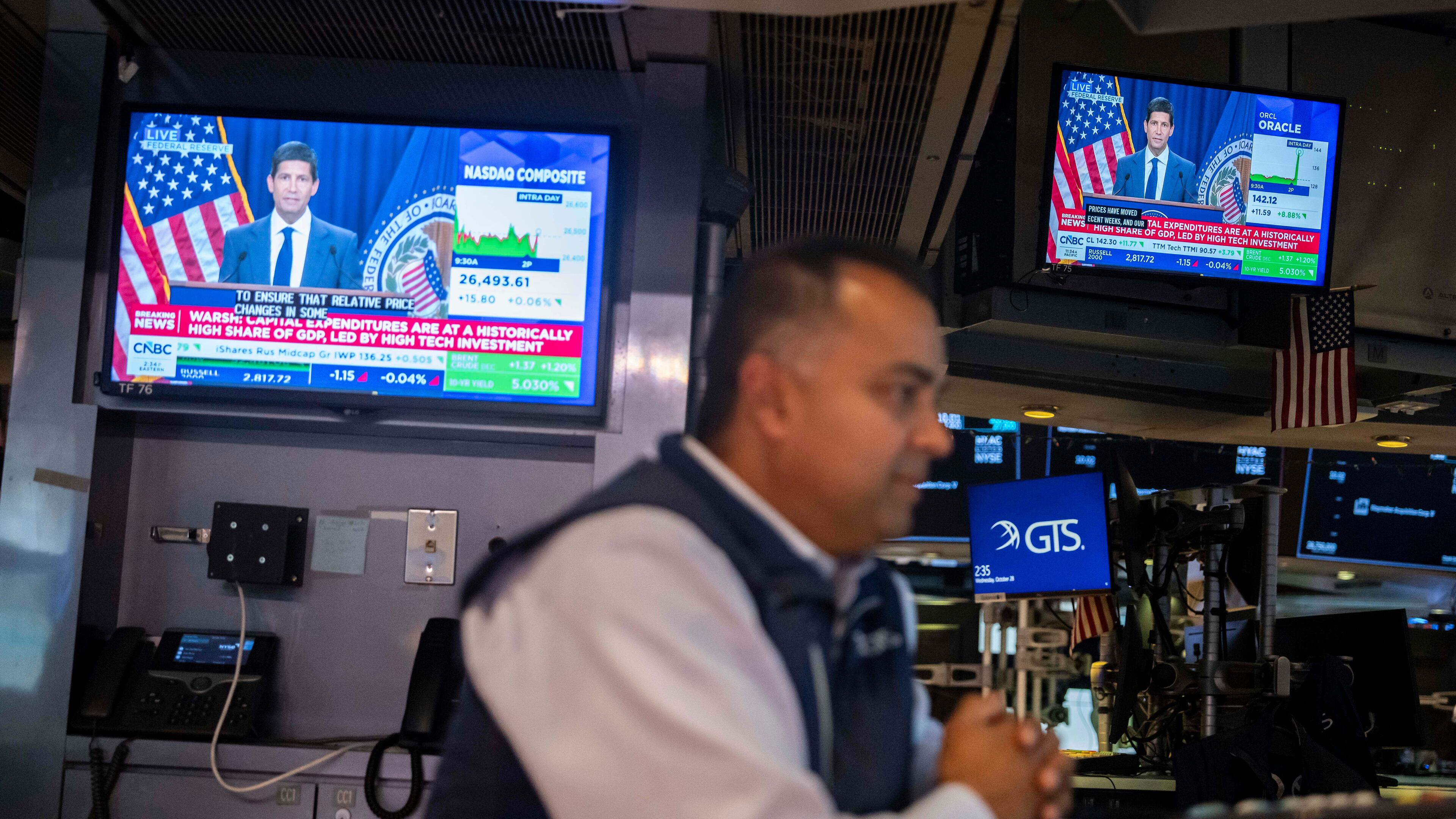 A screen displays a news conference by Federal Reserve Board Chairman Kevin Warsh on the floor of the New York Stock Exchange, Wednesday, Oct. 28, 2026, in New York. (AP Photo/Yuki Iwamura)