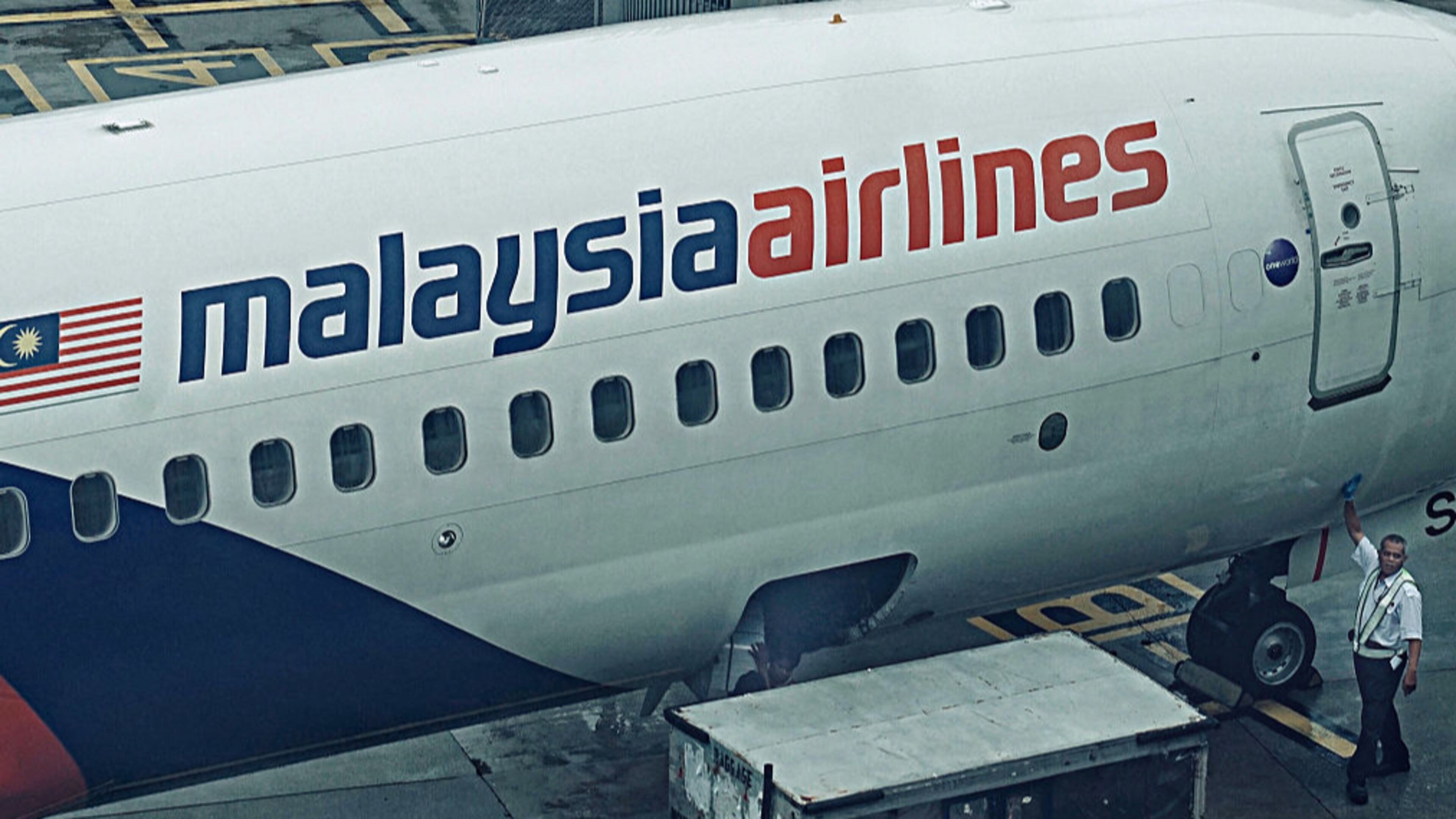 Malaysian Airlines ramp crews unloading the cargo from an aircraft at the busy terminal of Kuala Lumpur International airport on January 23, 2017 in Sepang, Malaysia.