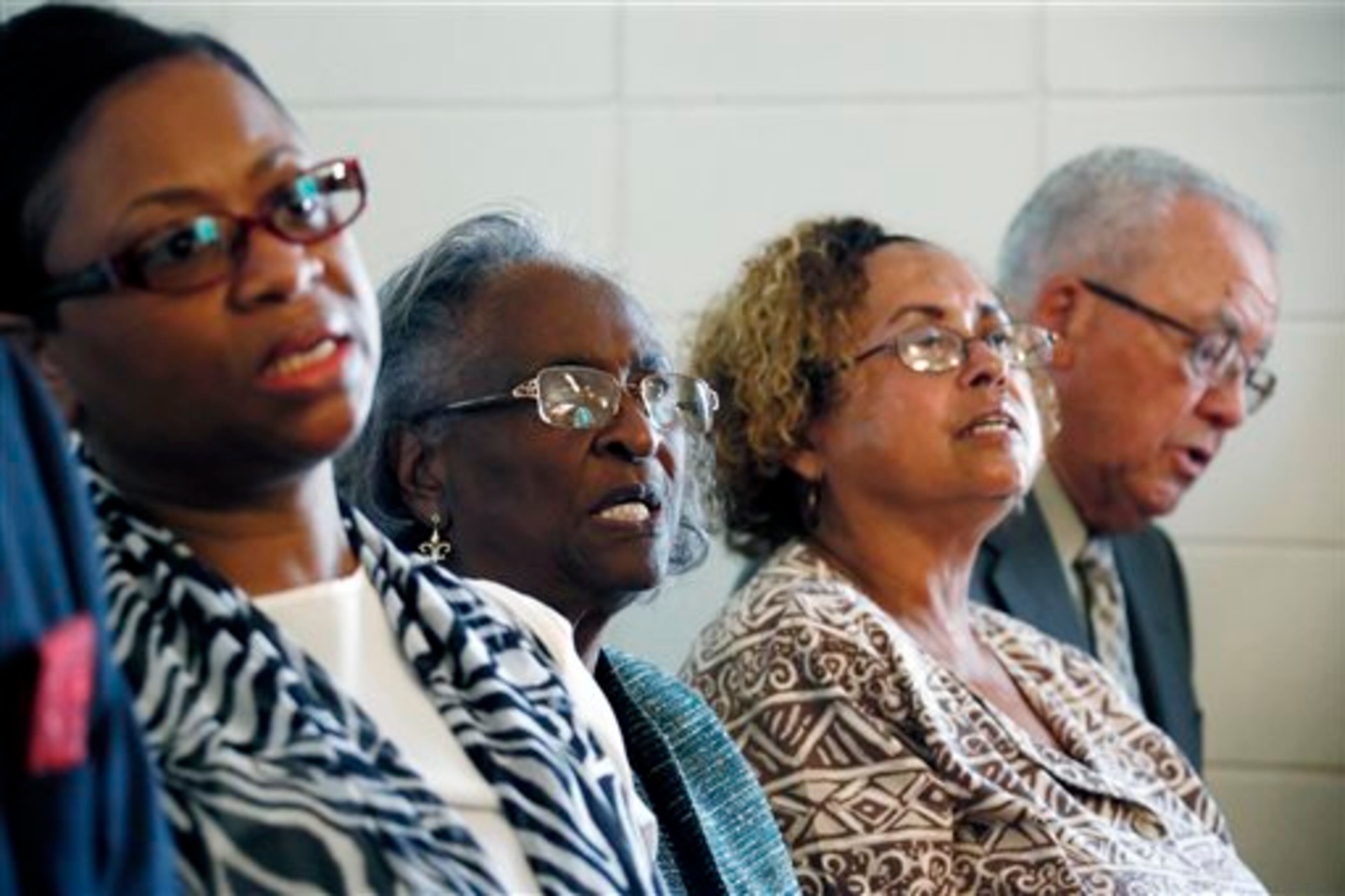 Julia Chaney Moss, left, daughter of slain civil rights worker James Chaney, sings with Ellie Dahmer, second from left, her daughter Bettie Dahmer, and son Vernon Dahmer Jr., at the Mt. Zion United Methodist Church in Philadelphia, Miss., Sunday, June 15, 2014, during a commemorative service for three civil rights workers killed in Neshoba County for their voter registration work among blacks in then segregationist Mississippi. Vernon Dahmer Sr., husband and father was killed in 1966 as a result of burns from a fire bombing of his home and businesses or his efforts register blacks to vote. (AP Photo/Rogelio V. Solis)