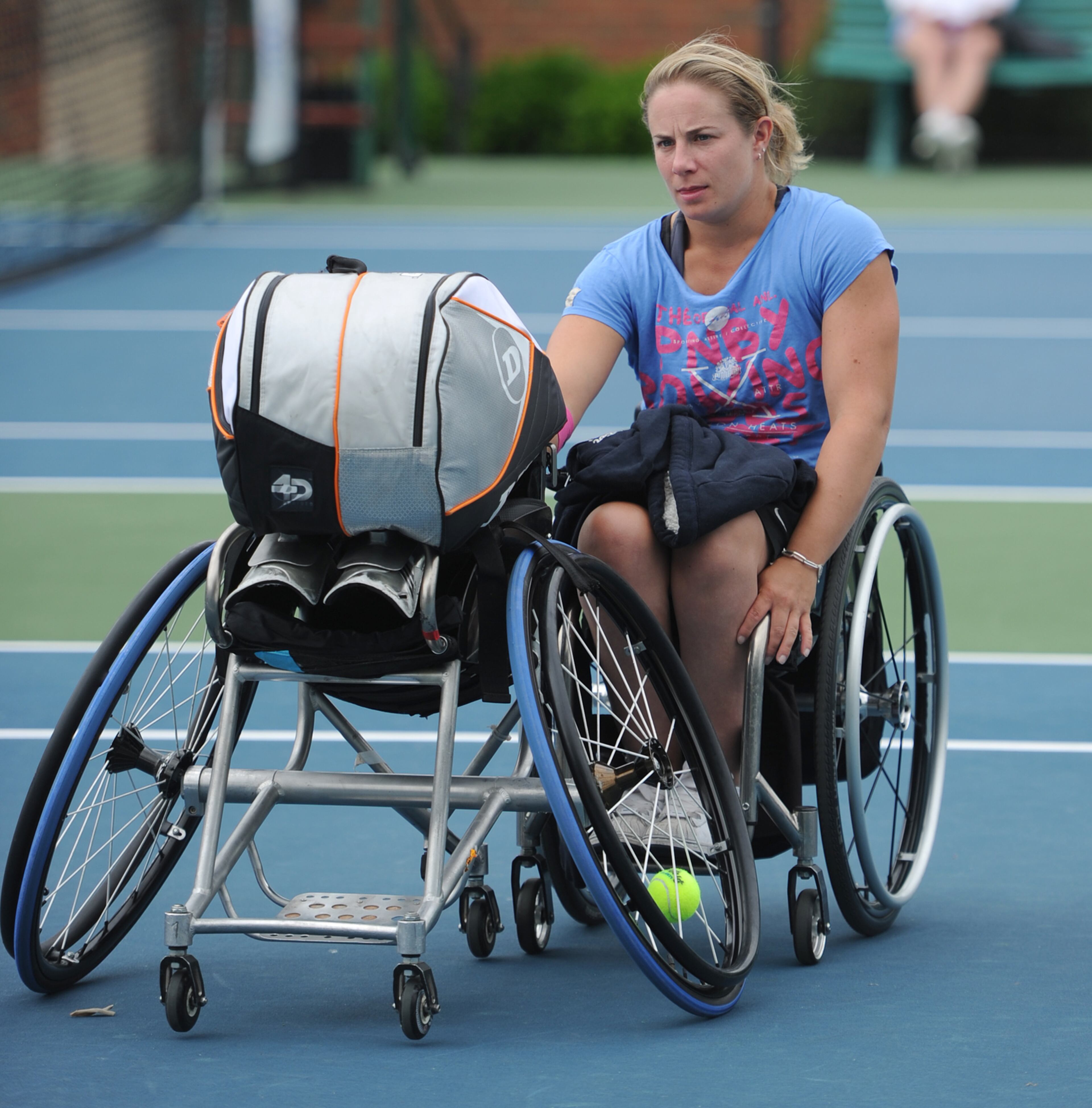 Lucy Shuker, South Africa, pushes a wheelchair with her tennis bag during the Atlanta Open Wheelchair Tennis Championships at the Dunwoody Country Club on Wednesday, May 1, 2013. JOHNNY CRAWFORD / JCRAWFORD@AJC.COM