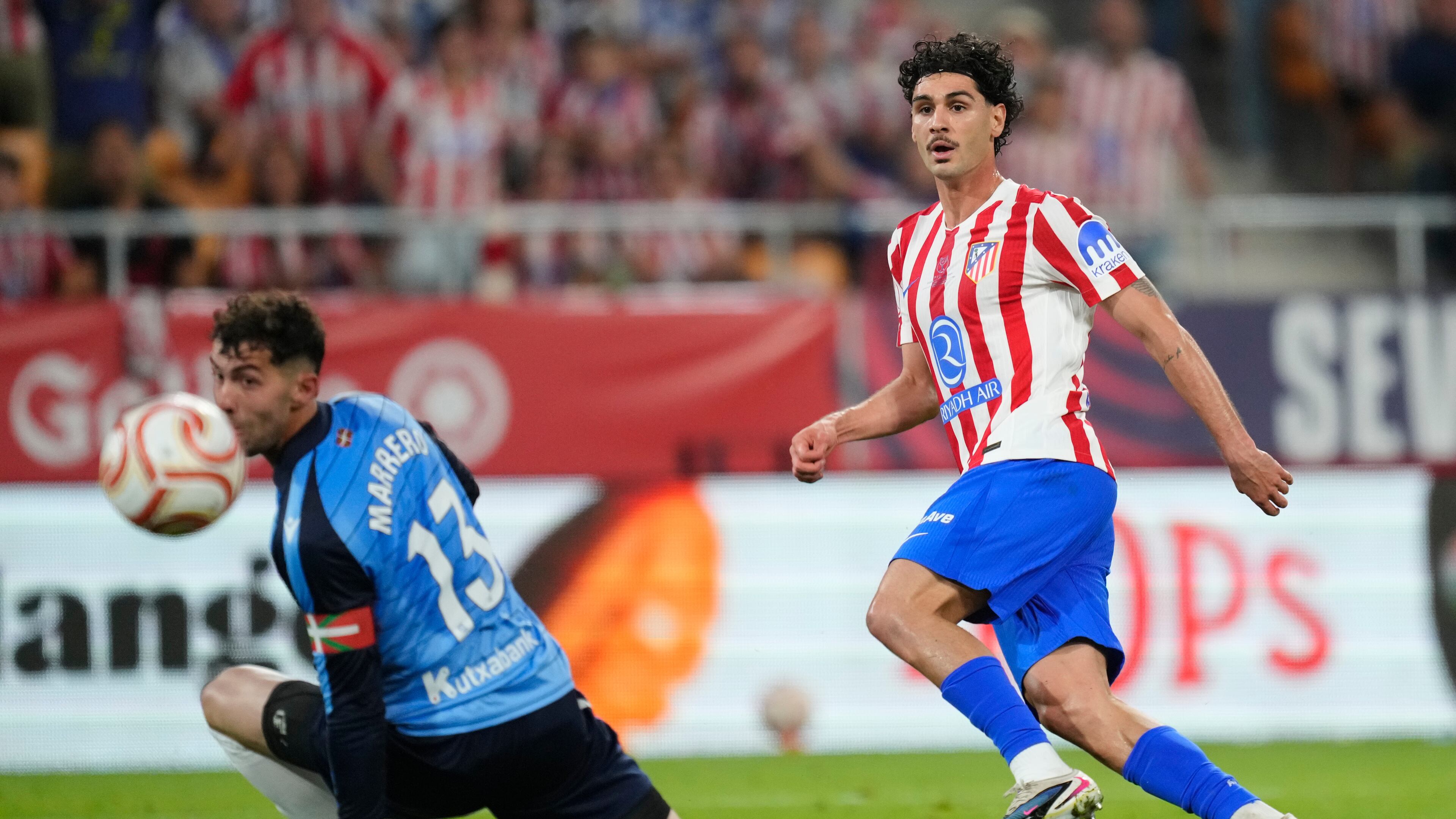 Atletico Madrid's Johnny Cardoso, right, shoots the ball past Real Sociedad's goalkeeper Unai Marrero during the Copa del Rey final soccer match between Atletico Madrid and Real Sociedad in Seville, Spain, Saturday, April. 18, 2026. (AP Photo/Jose Breton)