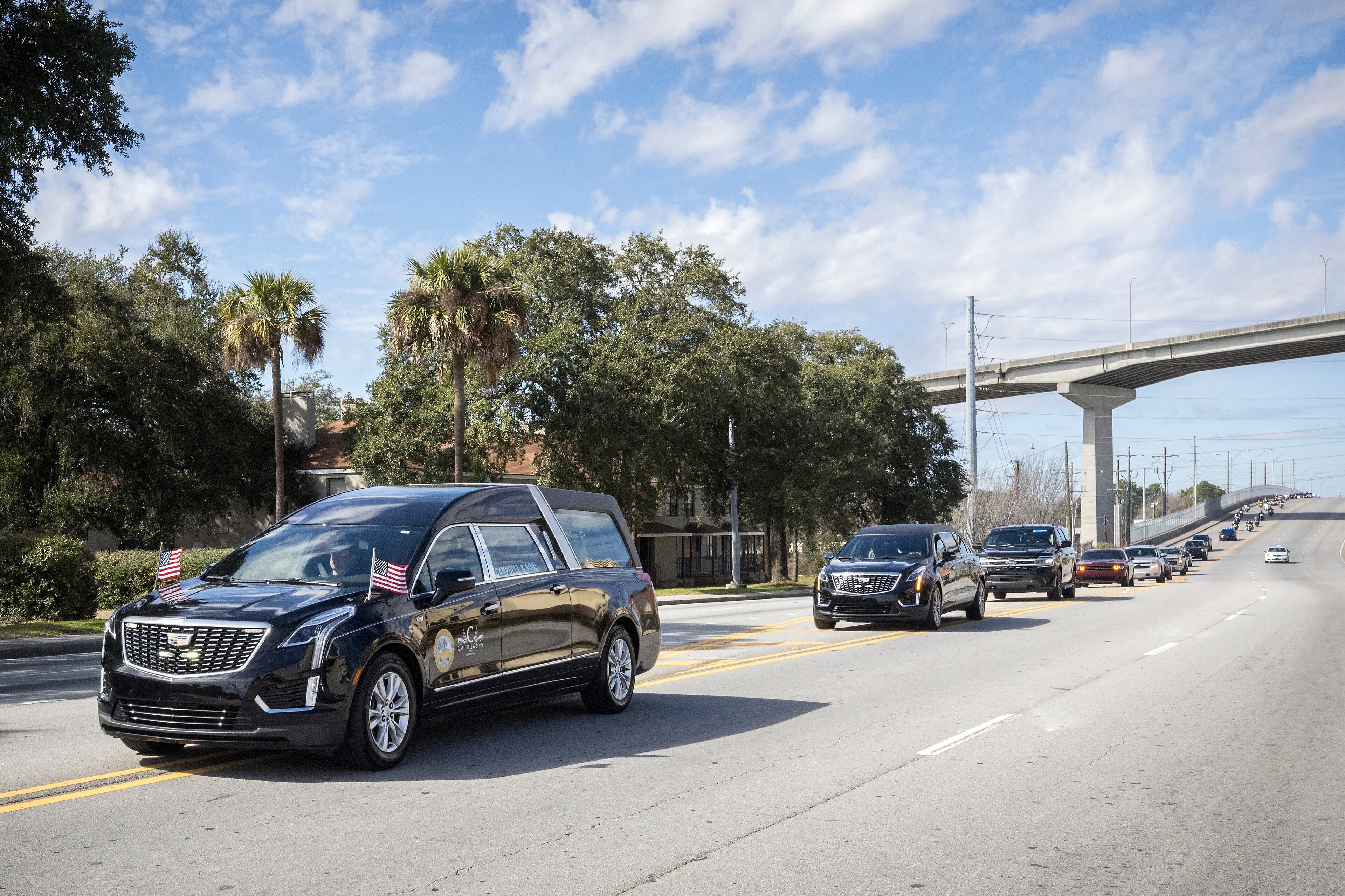 The hearse carrying remains of U.S. Army Reservist Sgt. Breonna Moffett nears downtown during a motorcade procession carrying her back home, Thursday, Feb. 15, 2024, Savannah, Ga. (AJC Photo/Stephen B. Morton)