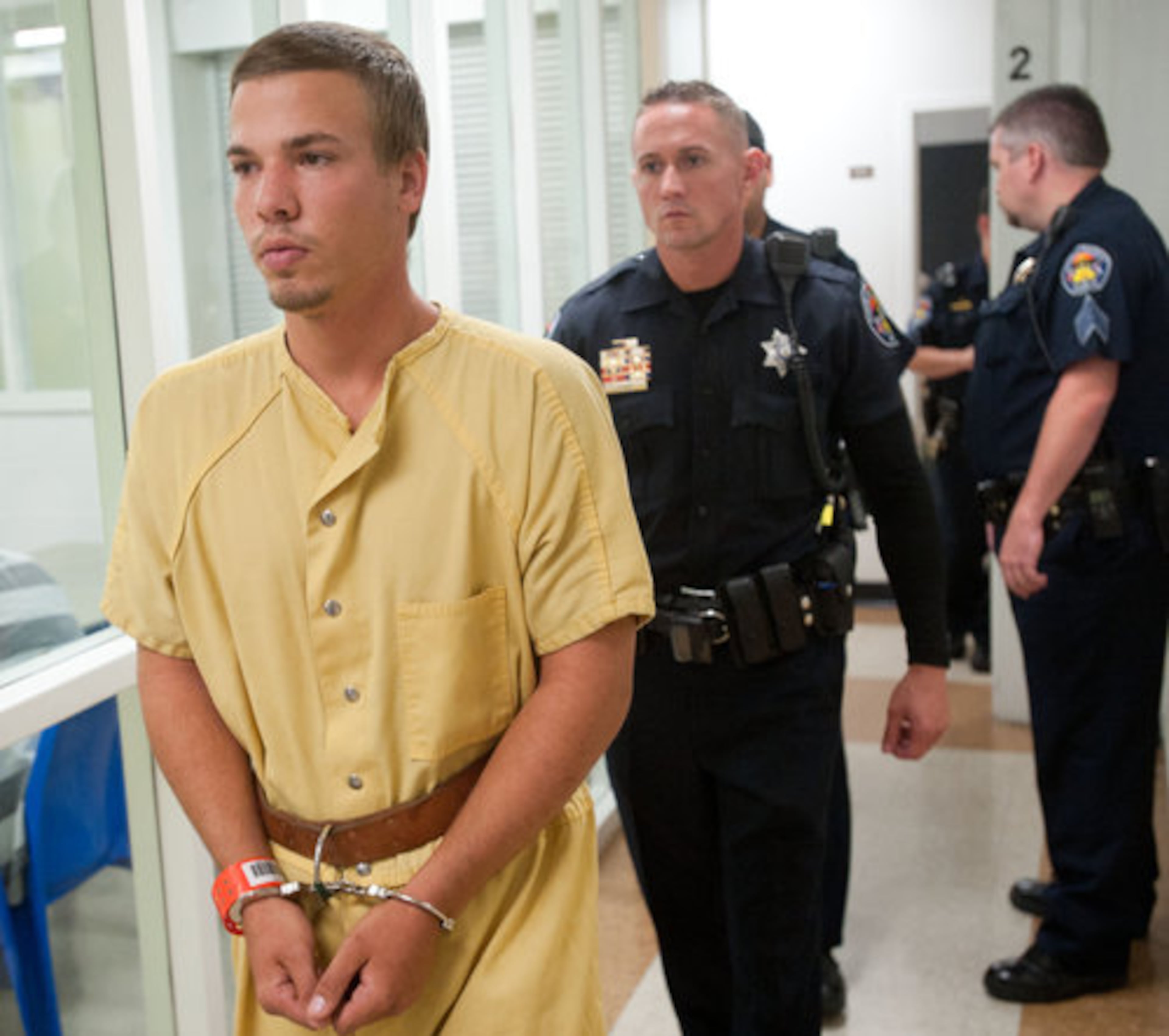 Ryan Edward Dougherty is brought to an advisement hearing at the Pueblo County Sheriff's Office detention center in Pueblo, Colo. He and his siblings made their first court appearance Thursday in Pueblo, Colo., appearing by video from jail. None made any statement during the brief hearing.