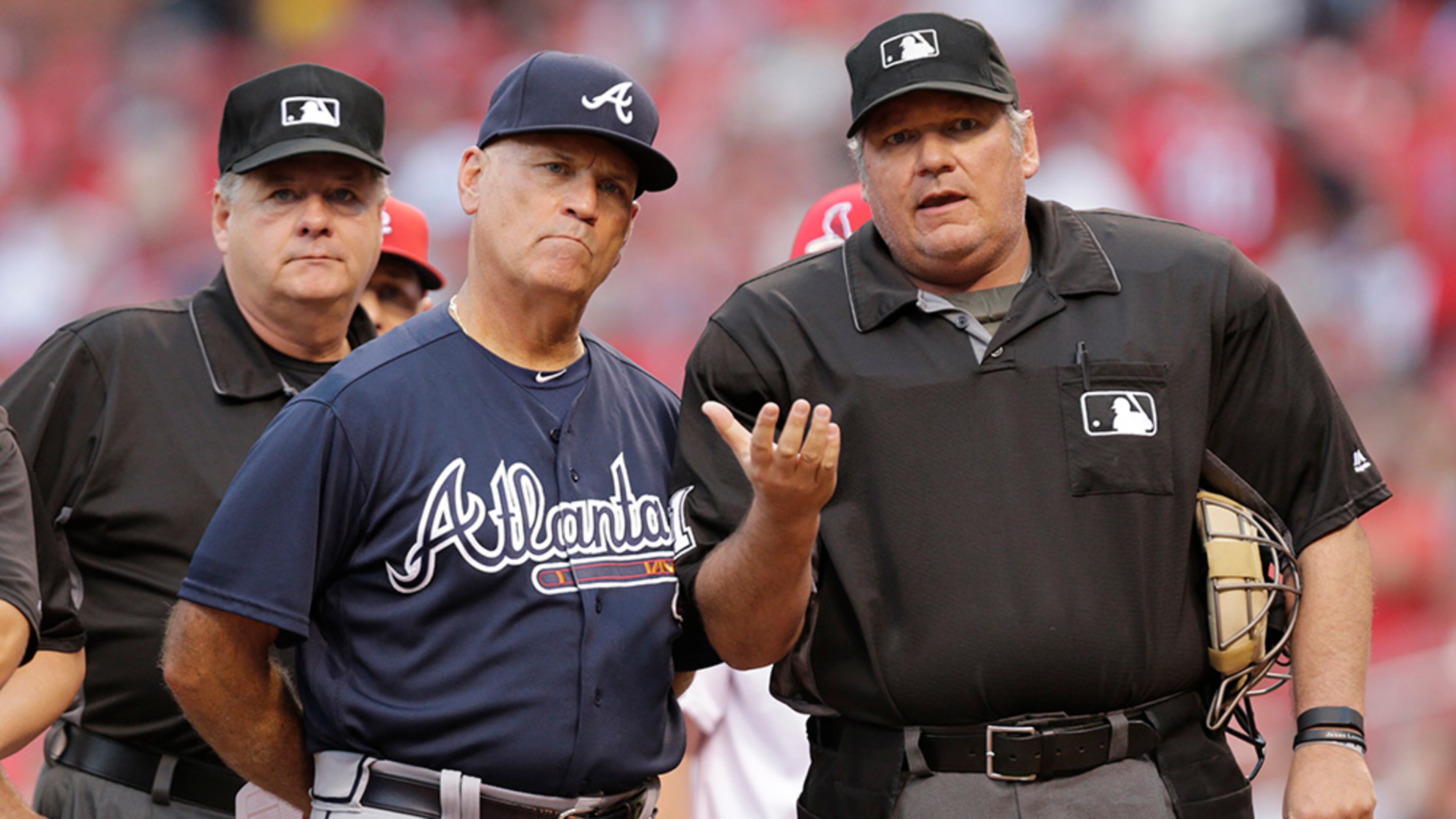 Home plate umpire Hunter Wendelstedt points out the eccentricities of Busch Stadium to Braves interim manager Brian Snitker prior to the Braves' baseball game against the St. Louis Cardinals, Friday, Aug. 5, 2016, in St. Louis.