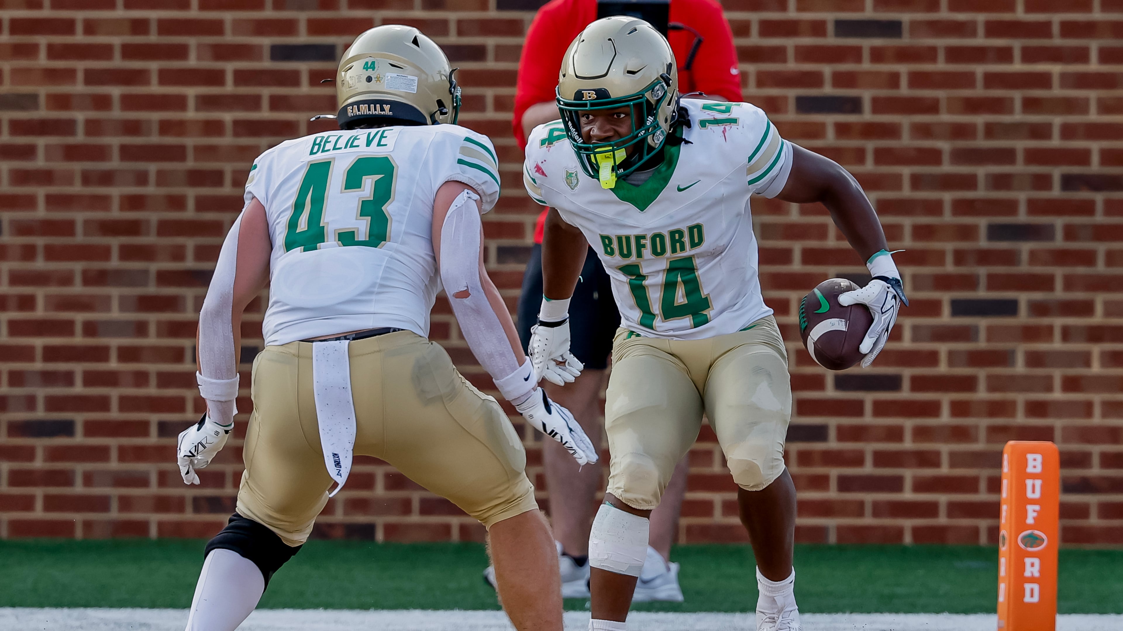 BufordÕs Tripp Chatmon (14) celebrates his touchdown with Jean-Marc Leboehi (43) during the second half of a high school football game between Buford and Gainesville, Saturday, Aug. 22, 2026, in Buford, GA. (Erik S. Lesser for the AJC)
