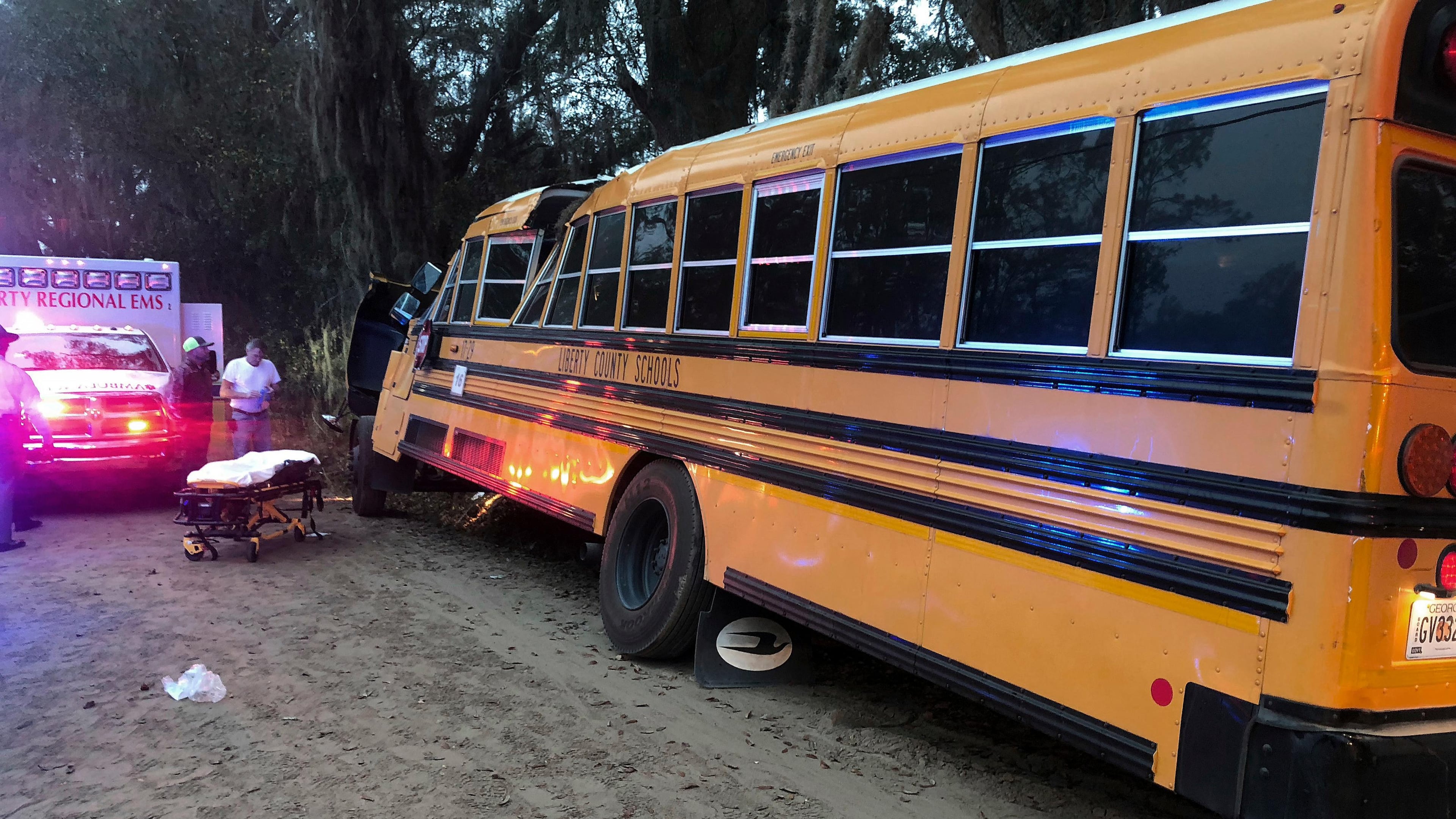 Authorities investigate the scene where a school bus crashed, Tuesday, Dec. 5, 2017, in Gum Branch, Ga. Liberty County Public Safety Director Mike Hodges said more than 20 children were riding the bus when it crashed into a tree during its morning pick-up route. (AP Photo/Lewis Levine)