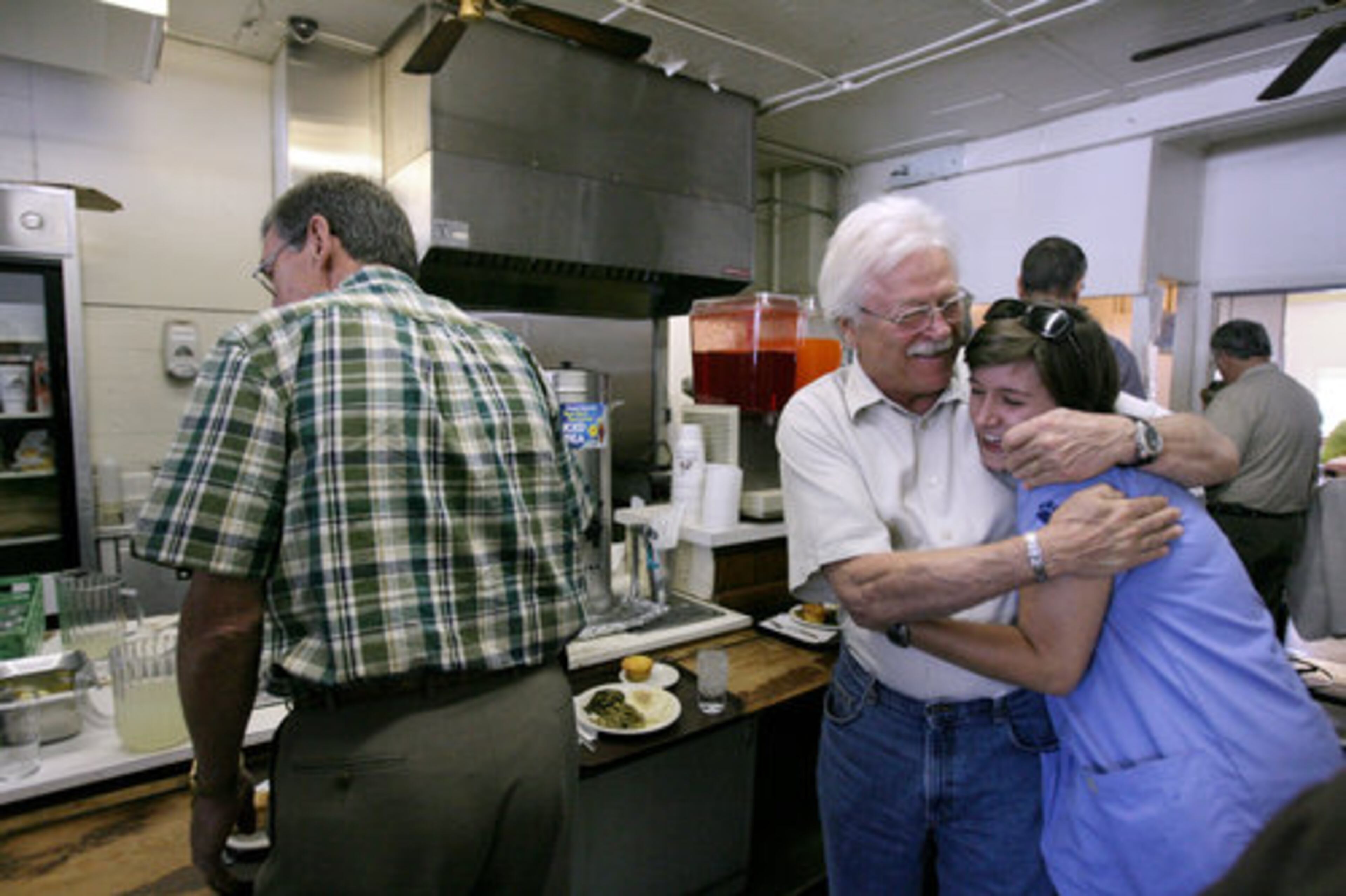 Mark Hubener hugs his friend Leah Sexton after running into her. Hubener is another longtime customer. He has been coming to Matthews since he was 13, more than 50 years.