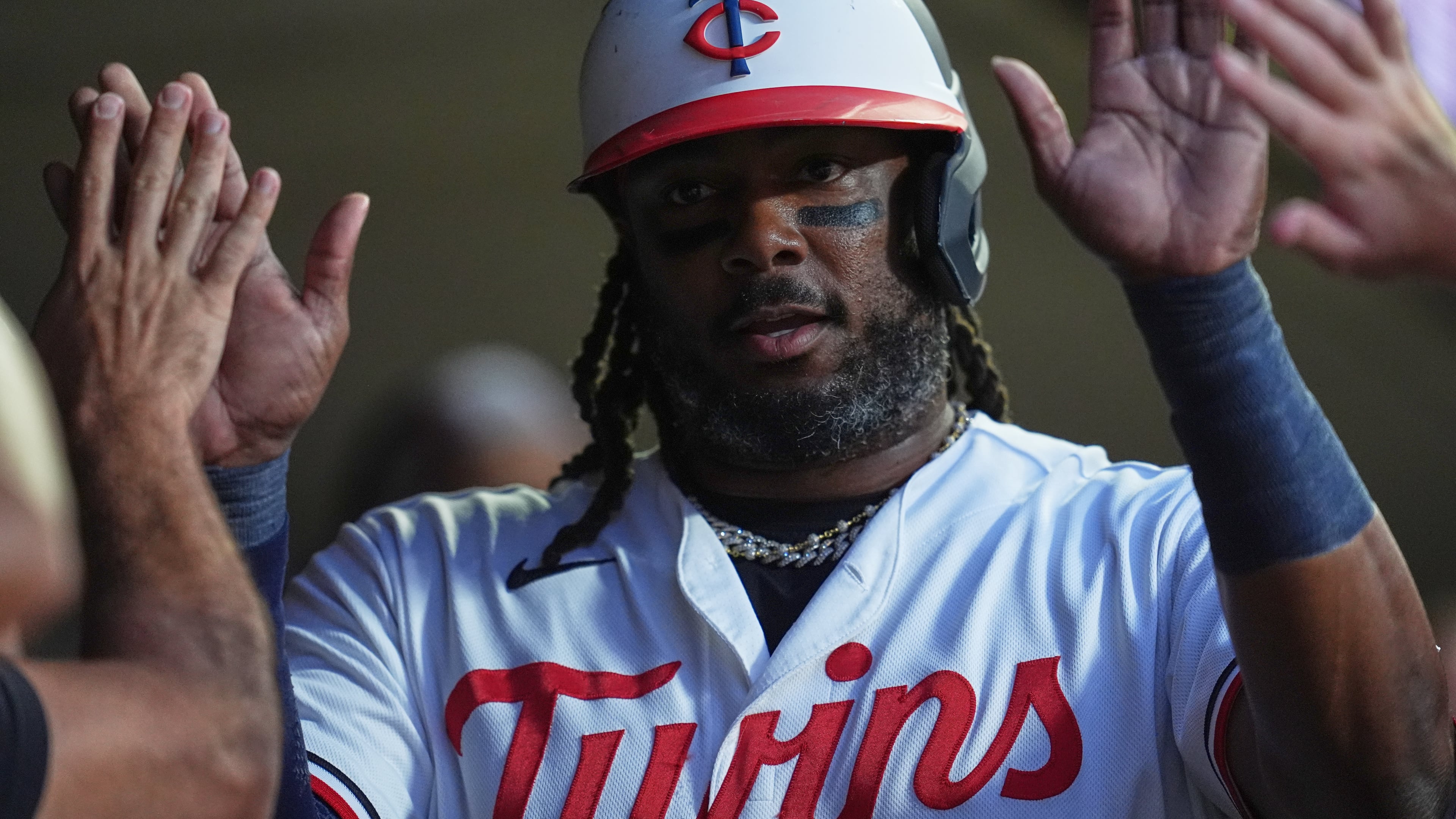 Minnesota Twins designated hitter Josh Bell celebrates in the dugout after scoring off a RBI single hit by Kody Clemens during the first inning of a baseball game against the Atlanta Braves, Monday, Aug. 17, 2026, in Minneapolis. (AP Photo/Abbie Parr)