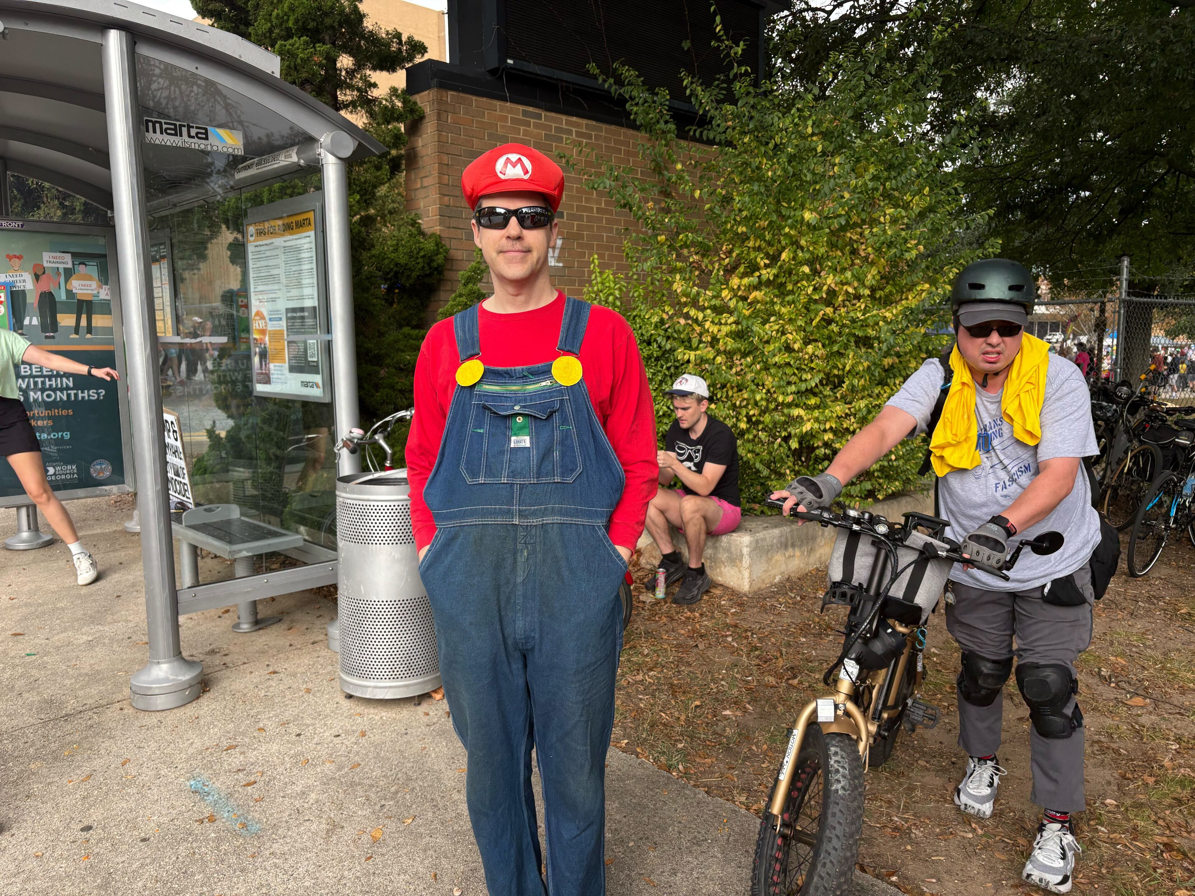 Sandy Springs resident Grant Flowers opted to dress up as “Mario” to a "No Kings" protest in Atlanta. (Shaddi Abusaid/AJC)