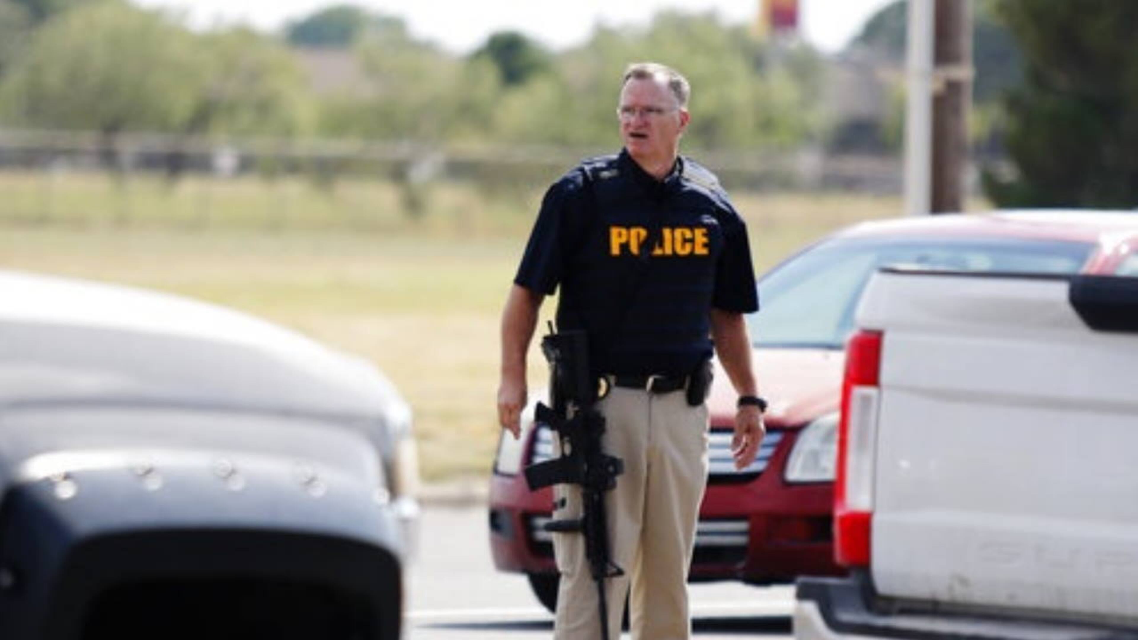 A law enforcement officer stands in the middle of the street in Odessa, Texas, after Saturday's shooting that left five people dead and 21 others injured.