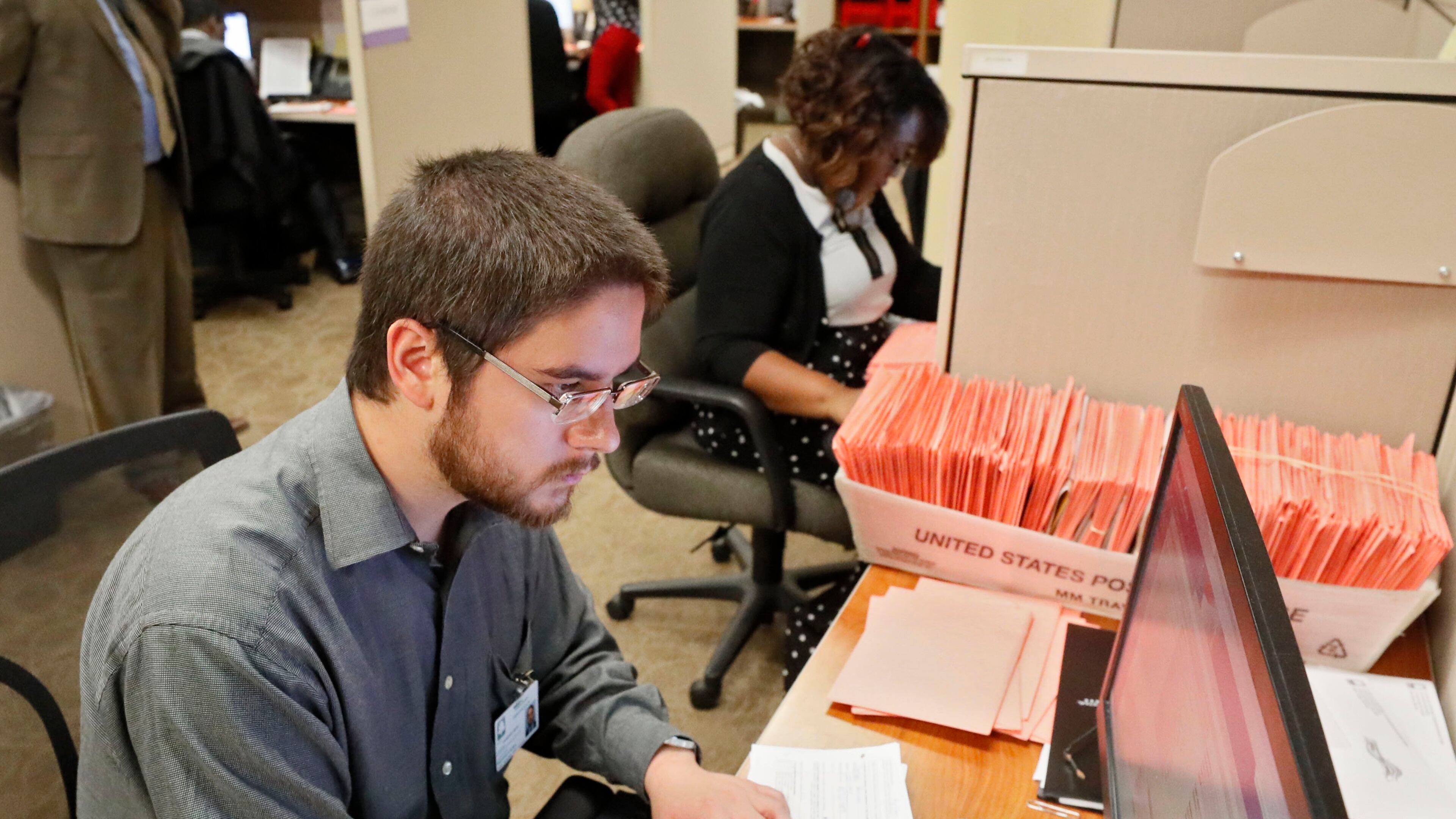 11/7/18 - Atlanta - David Laurencio and other registration specialists check provisional ballots at the Fulton County Board of Registration and Elections BOB ANDRES / BANDRES@AJC.COM