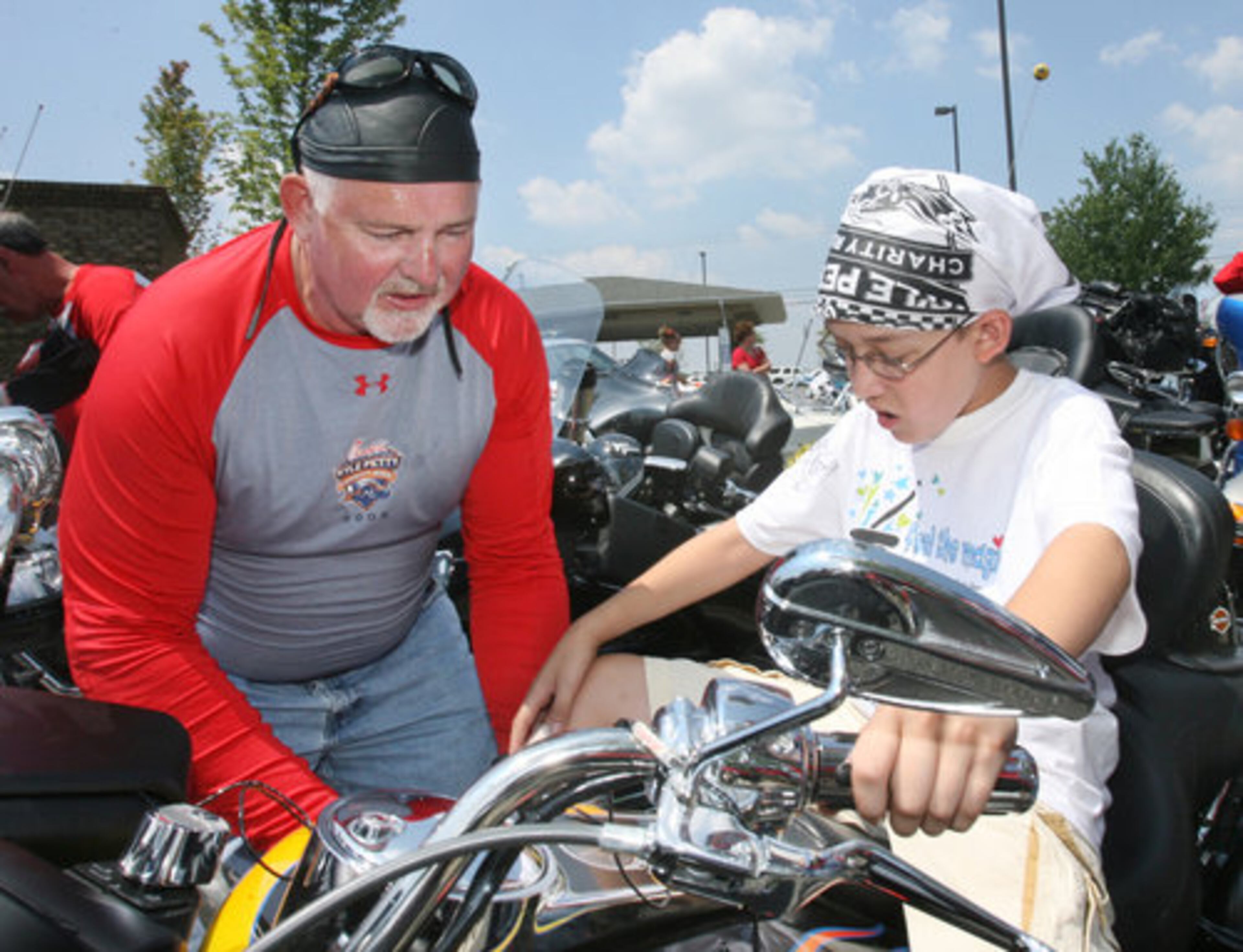 Now that's a big bike. Suwanee's Tony Velo, 10, tries out the saddle of Steve Wright's 2004 Harley-Davidson Road Glide. Too bad Velo has to wait seven more years until he's eligible for a street motorcycle license.