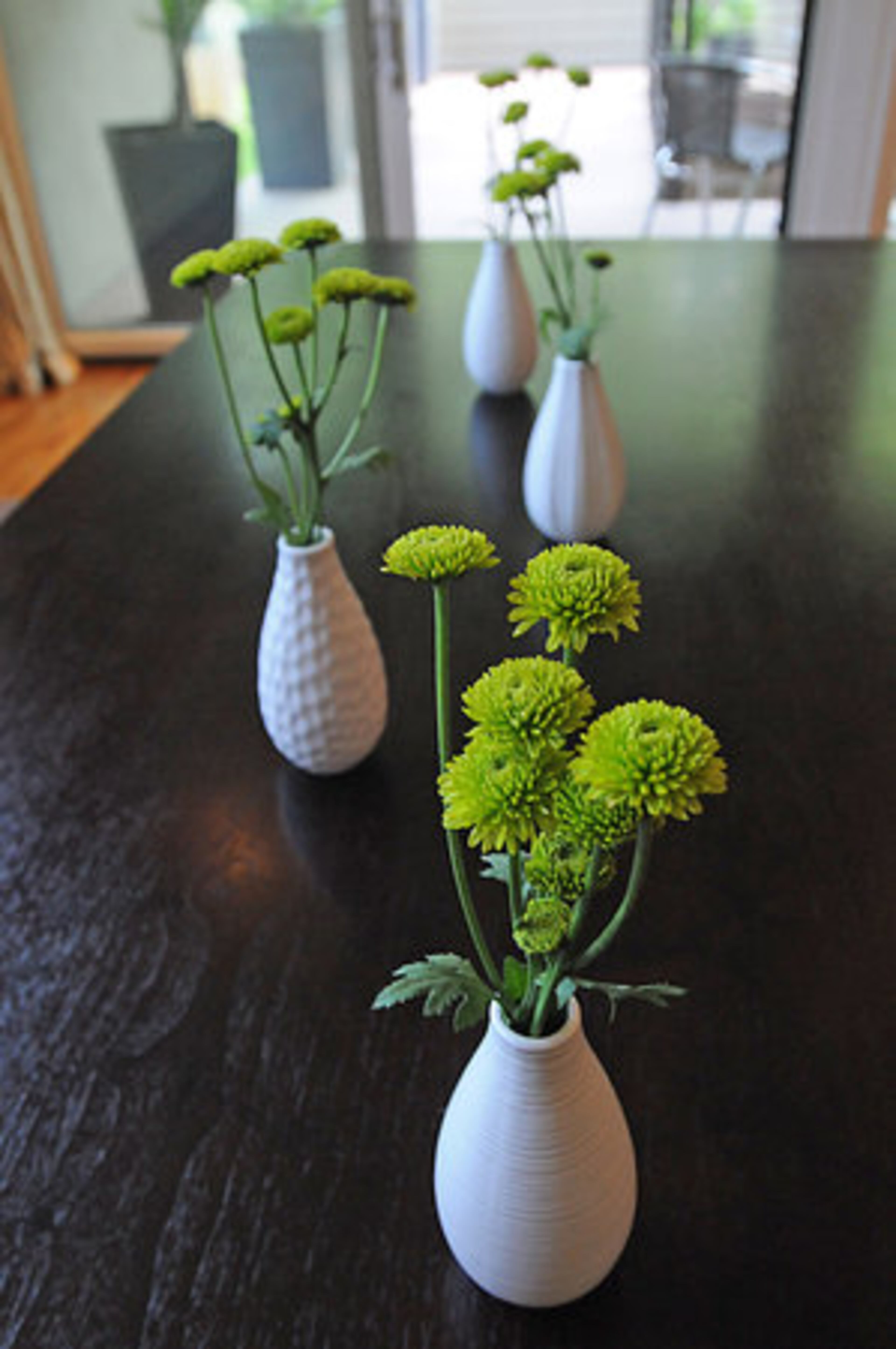 Throughout the home, the thoughtful placement of fresh flowers adds a vibrant burst of color.