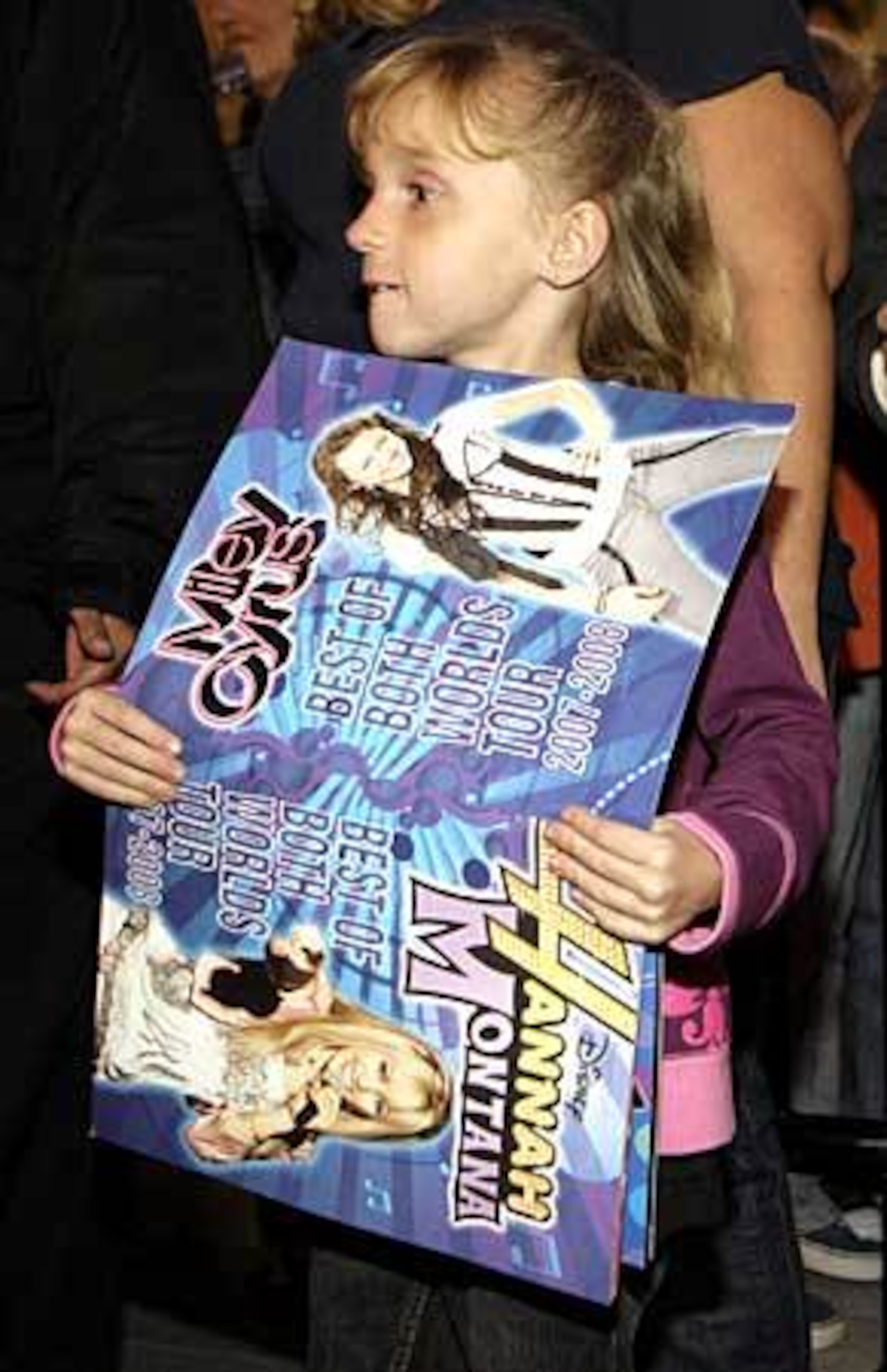 Seven-year-old Alyssa Gill waits her turn to get an autograph from actor Mitchel Musso at the Ultimate Miley Party Bus Tour 2007.