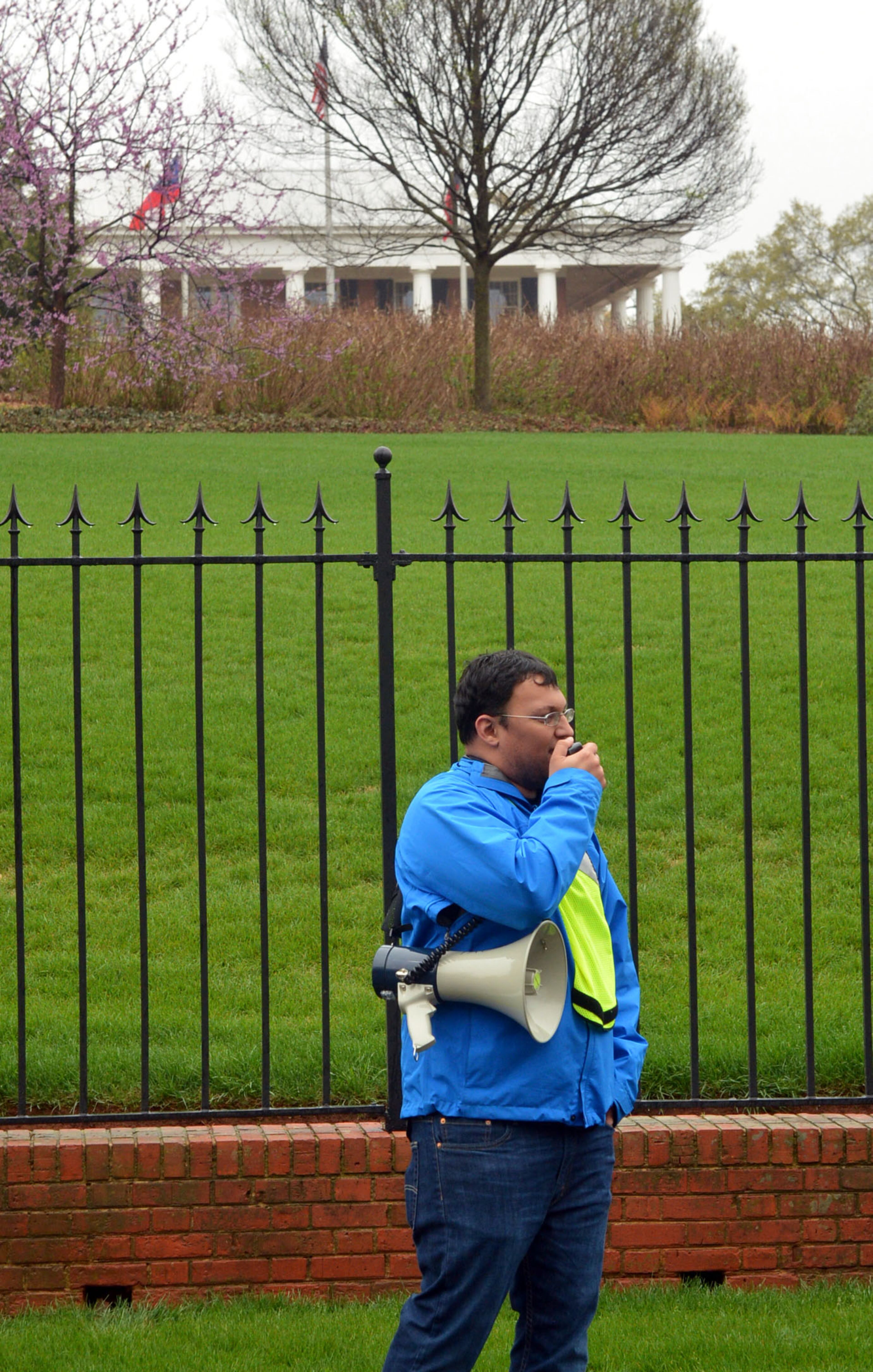 Neil Sordana uses a megaphone to chant with protestors. About 75 protesters, including several Atlanta clergy members, called on Gov. Nathan Deal to expand Medicaid services in the state. KENT D. JOHNSON / KDJOHNSON@AJC.COM