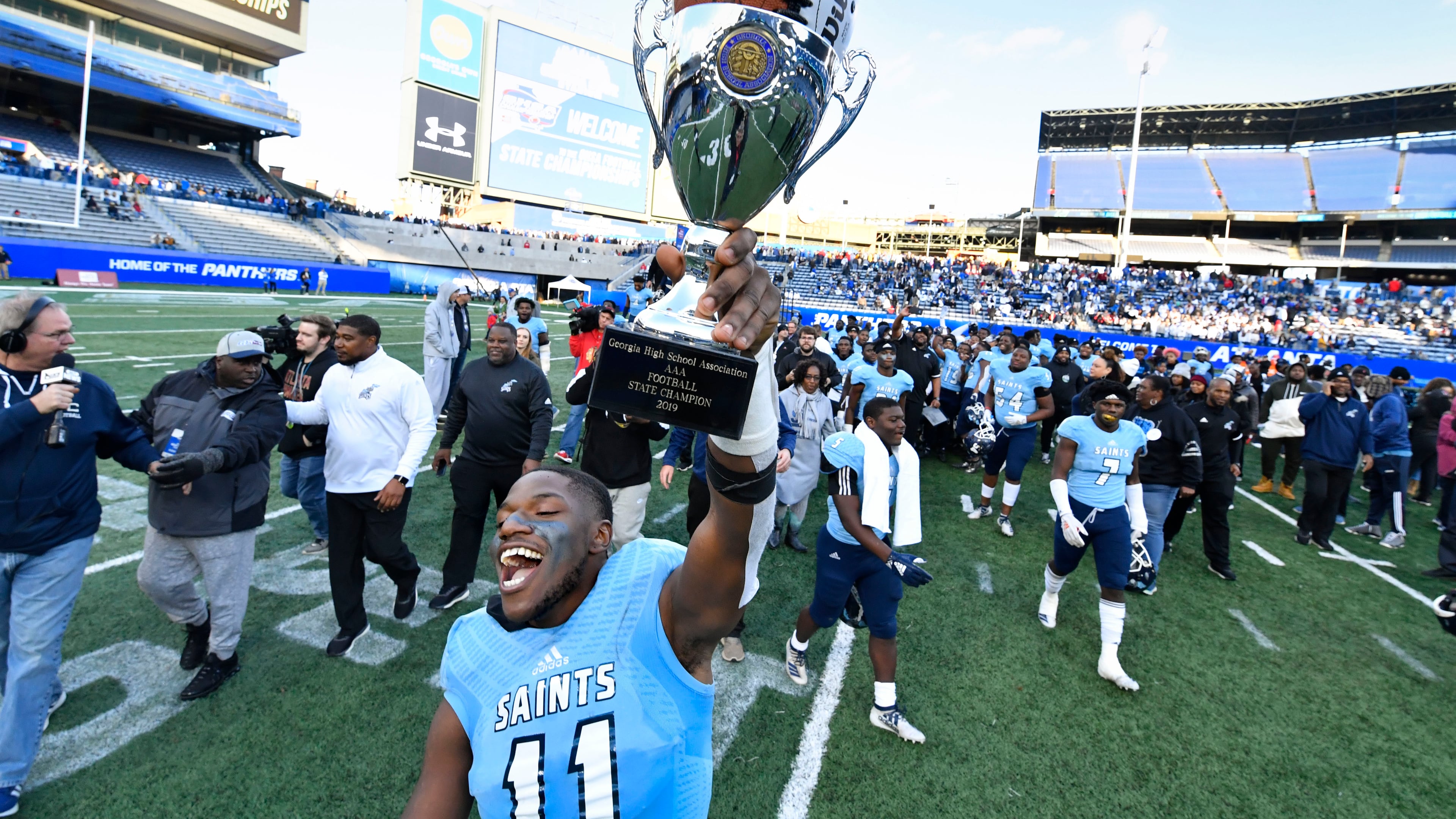 Cedar Grove's Isaiah Ratcliff celebrates with the trophy.