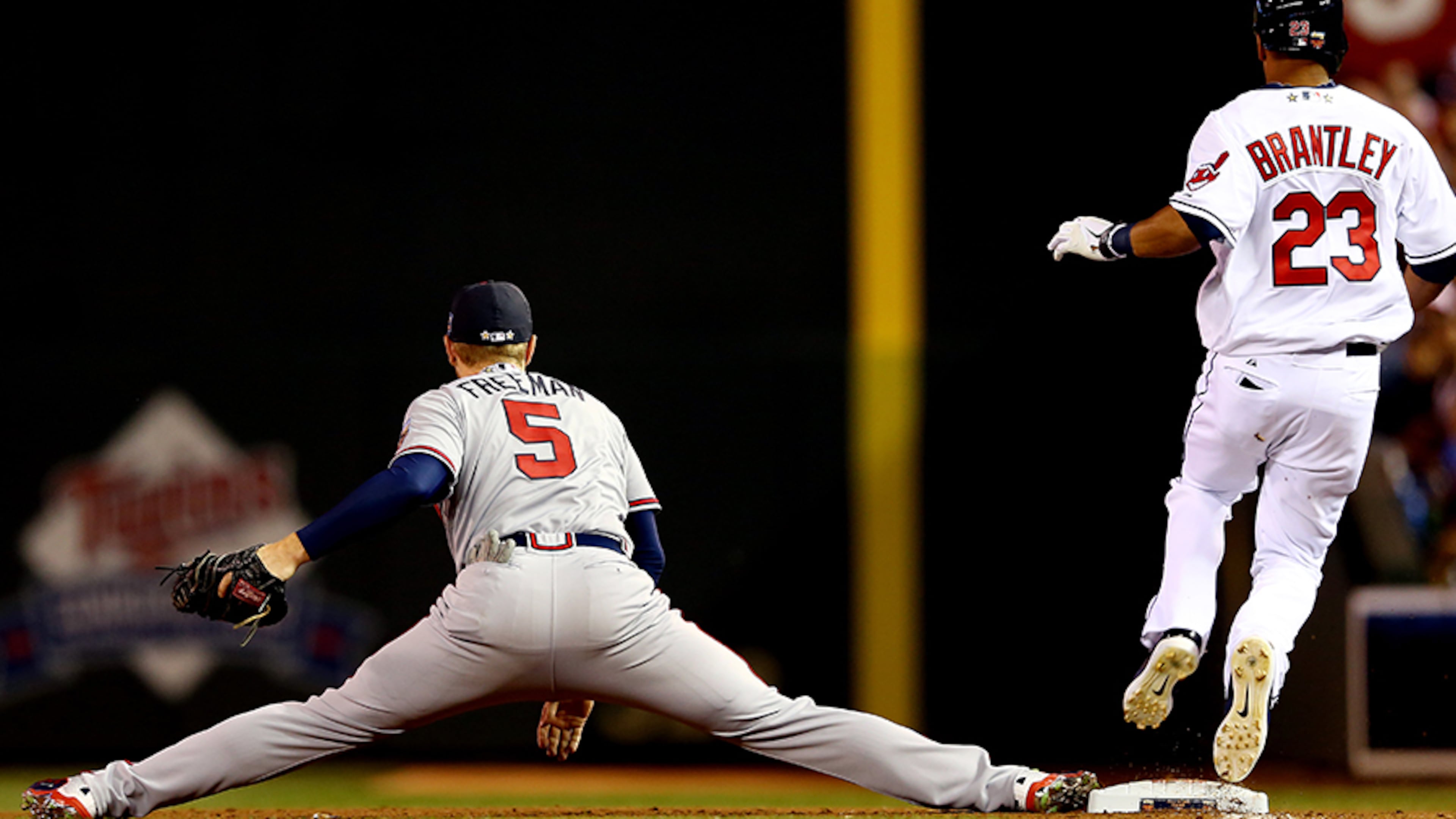 Atlanta Braves All-Star first baseman Freddie Freeman stretches to make a catch as Michael Brantley, of the Cleveland Indians, runs to first base during the 85th MLB All-Star Game at Target Field on July 15, 2014 in Minneapolis.