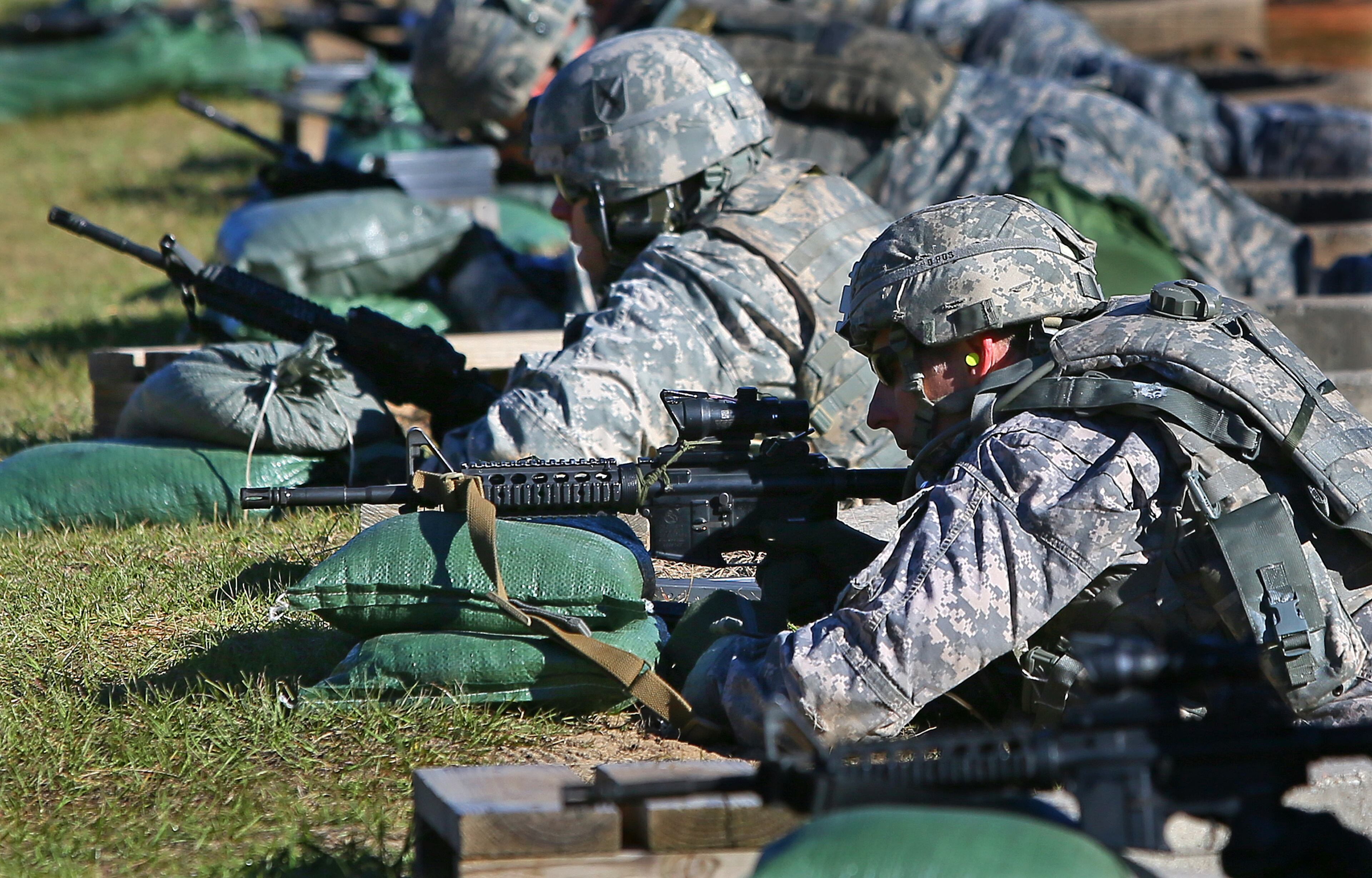 Major Matt Howard (left), Dahlonega, and Captain Craig Keller (right), Marietta, zero their weapons at the firing range while training for deployment to Afghanistan at Fort Stewart on Wednesday, Nov. 13, 2013, near Hinesville. About 200 soldiers with the 48th Brigade of the Georgia Army National Guard will deploy to Afghanistan just as other troops are winding down and coming home.