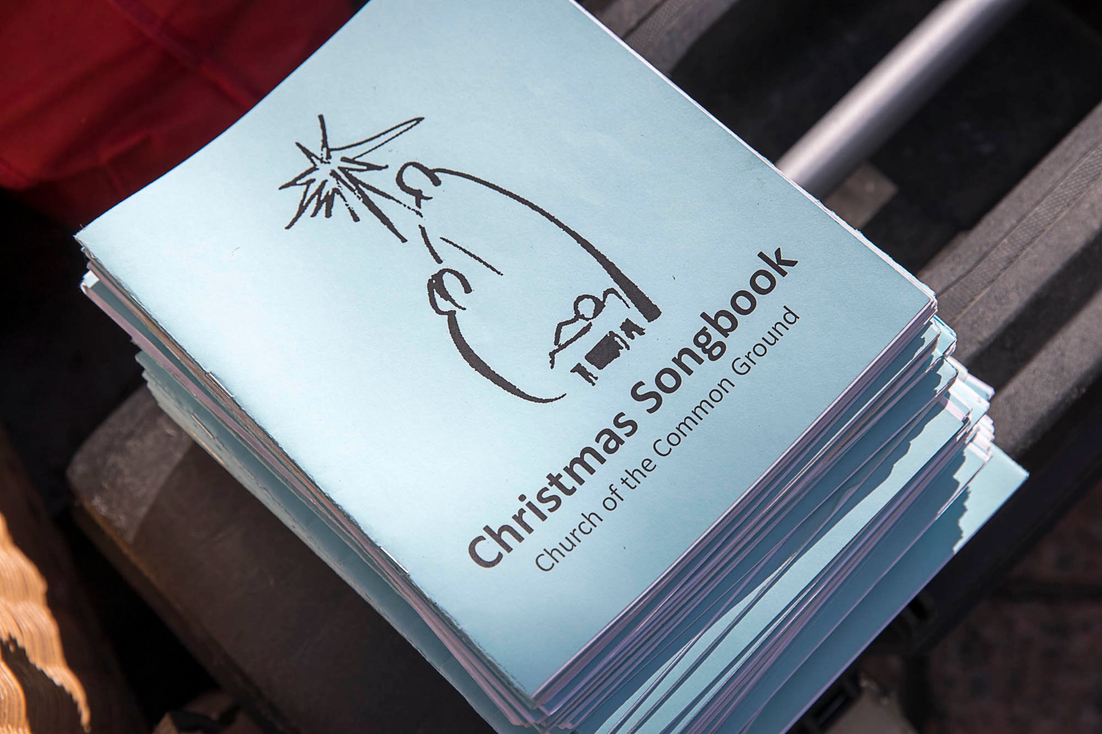 12/24/2018 -- Atlanta, Georgia -- Christmas Songbooks are passed out during a Church of the Common Ground Christmas Eve service for the homeless at Woodruff Park in Atlanta, Monday, December 24, 2018. (ALYSSA POINTER/ALYSSA.POINTER@AJC.COM)