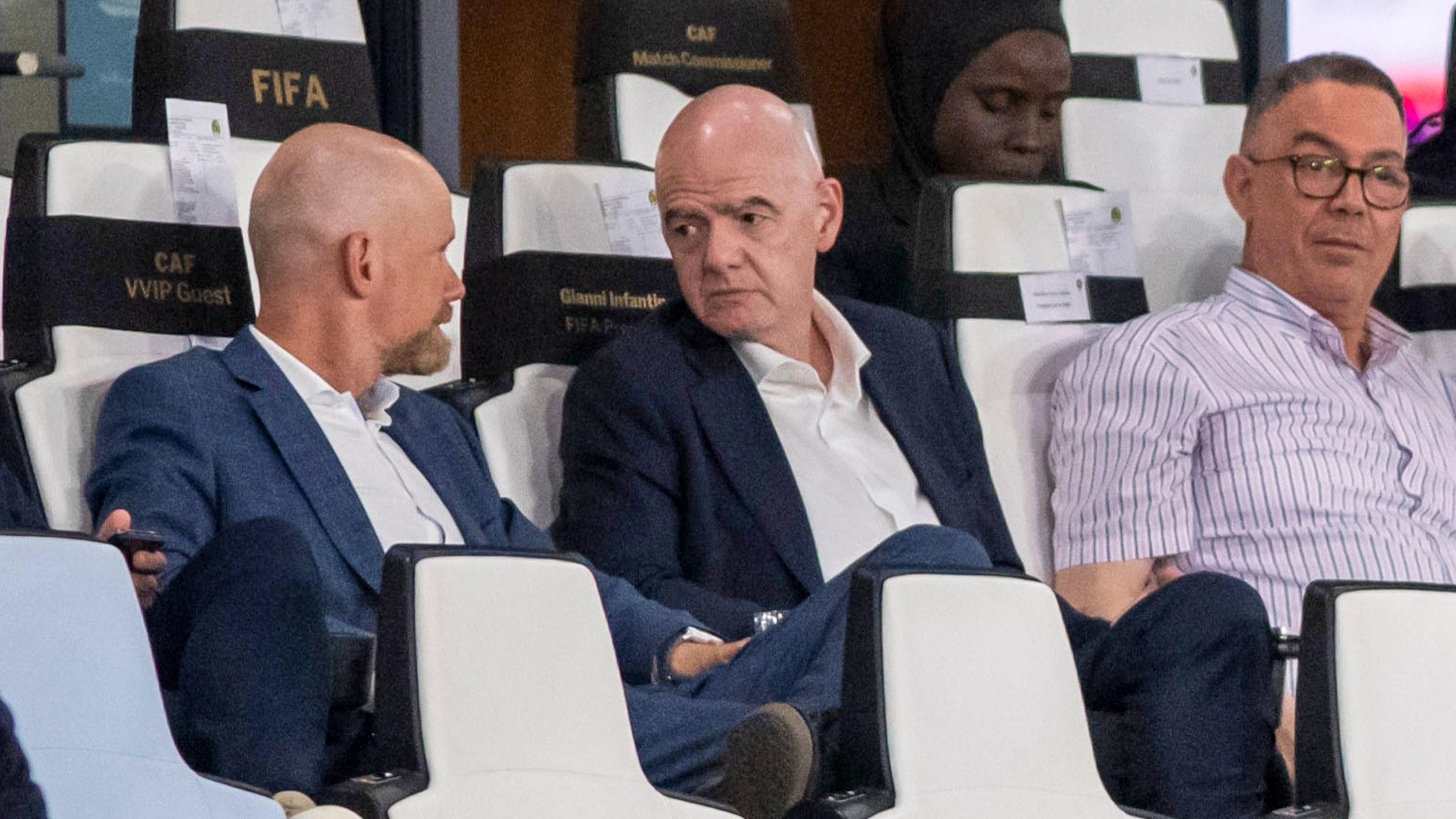 FIFA president Gianni Infantino, center, speaks to FIFA secretary general Mattias Grafstrom, left, sitting beside president of Moroccan Royal Football Federation Fouzi Lekjaa as they attend a Women's AFCON 2026 soccer match between Malawi and Zambia, in Rabat, Morocco, Wednesday, Aug. 5, 2026. (AP Photo)