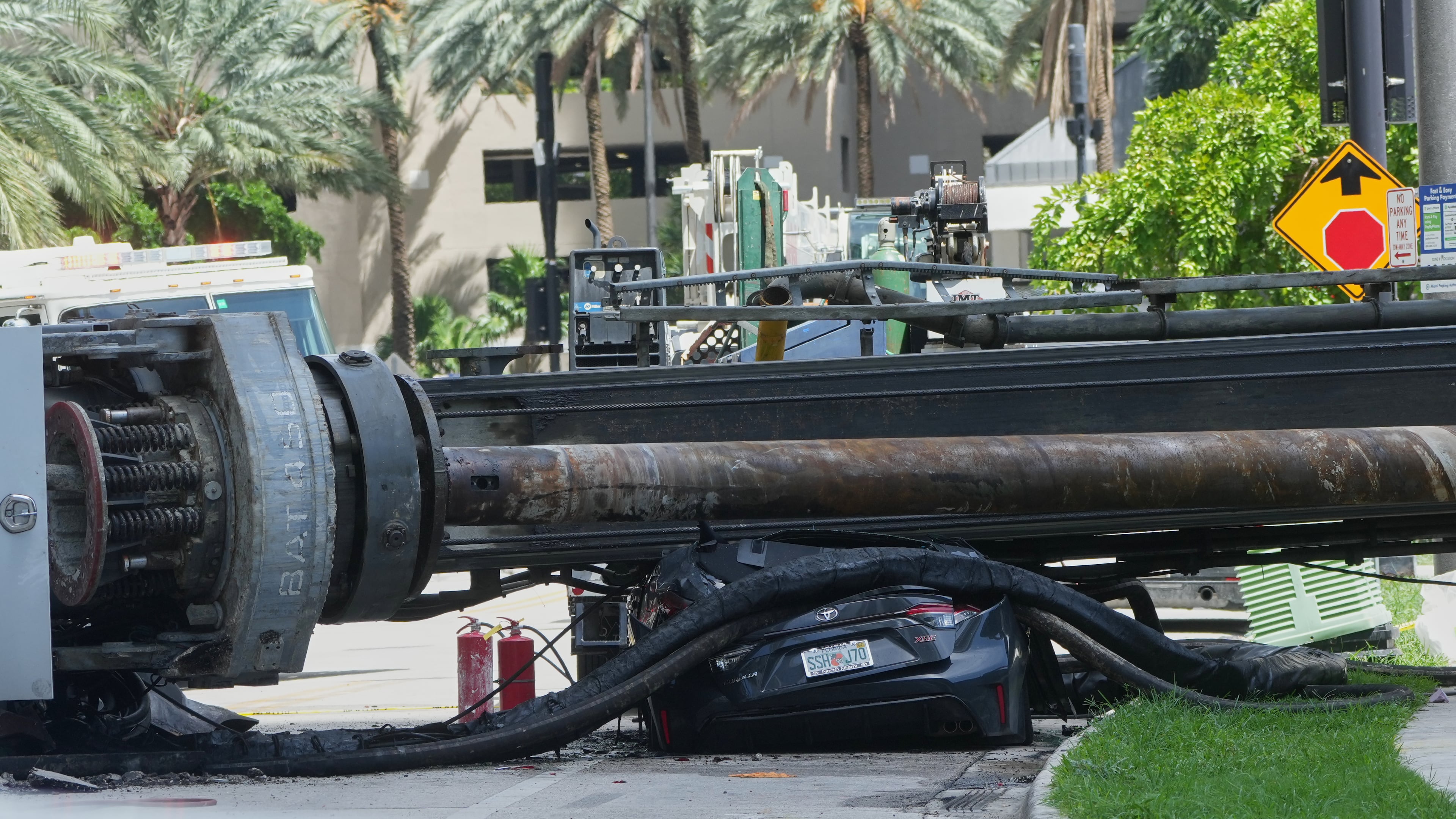 A large construction crane collapsed and crushed a car on Monday, Sept. 14, 2026, in Miami. (AP Photo/Marta Lavandier)