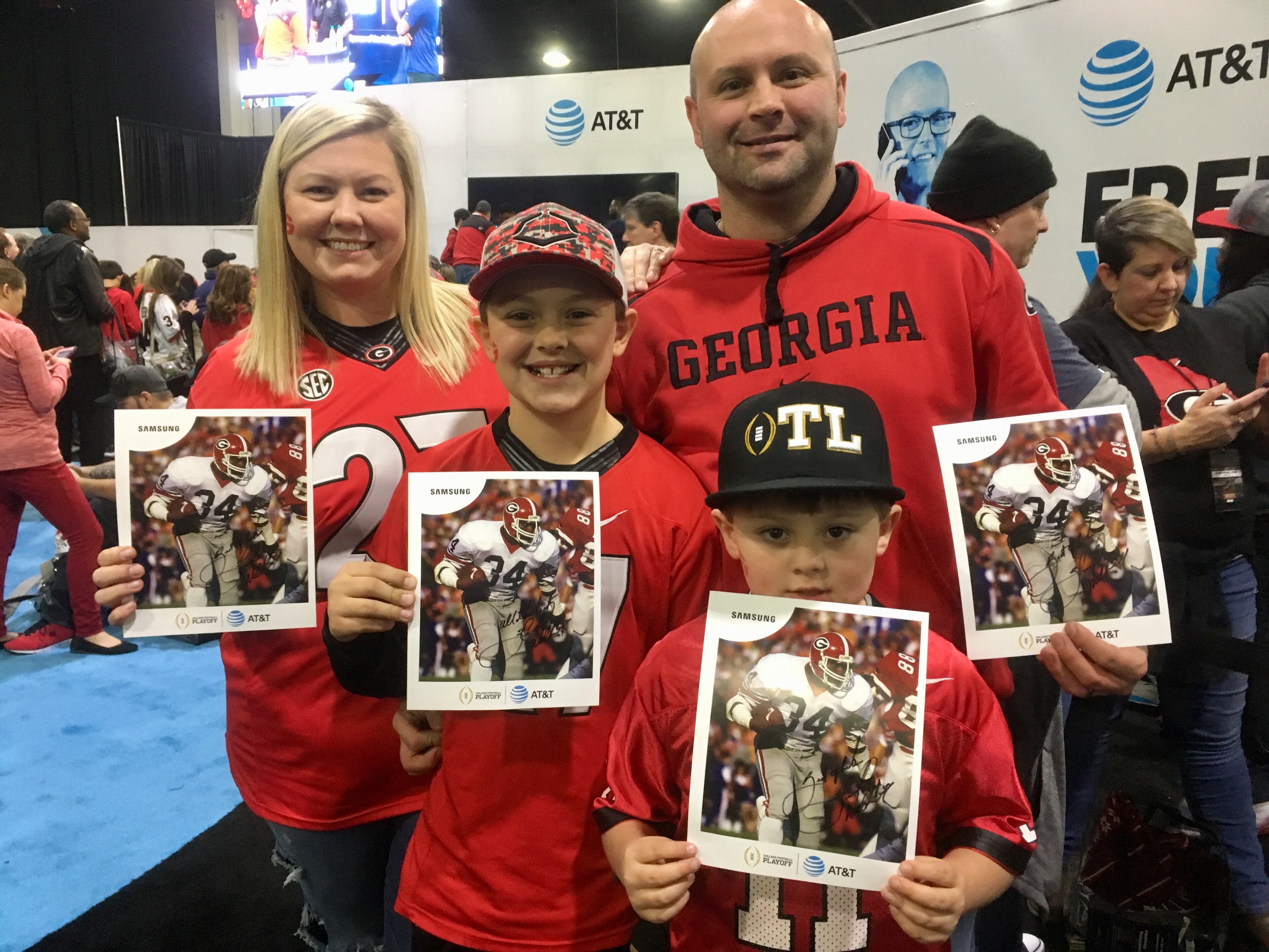 Hailey and Torey Wright and sons Aiden, 11, and Asher, 6, waited for three hours to meet Herschel Walker. None of them minded a bit. Photo: Jennifer Brett