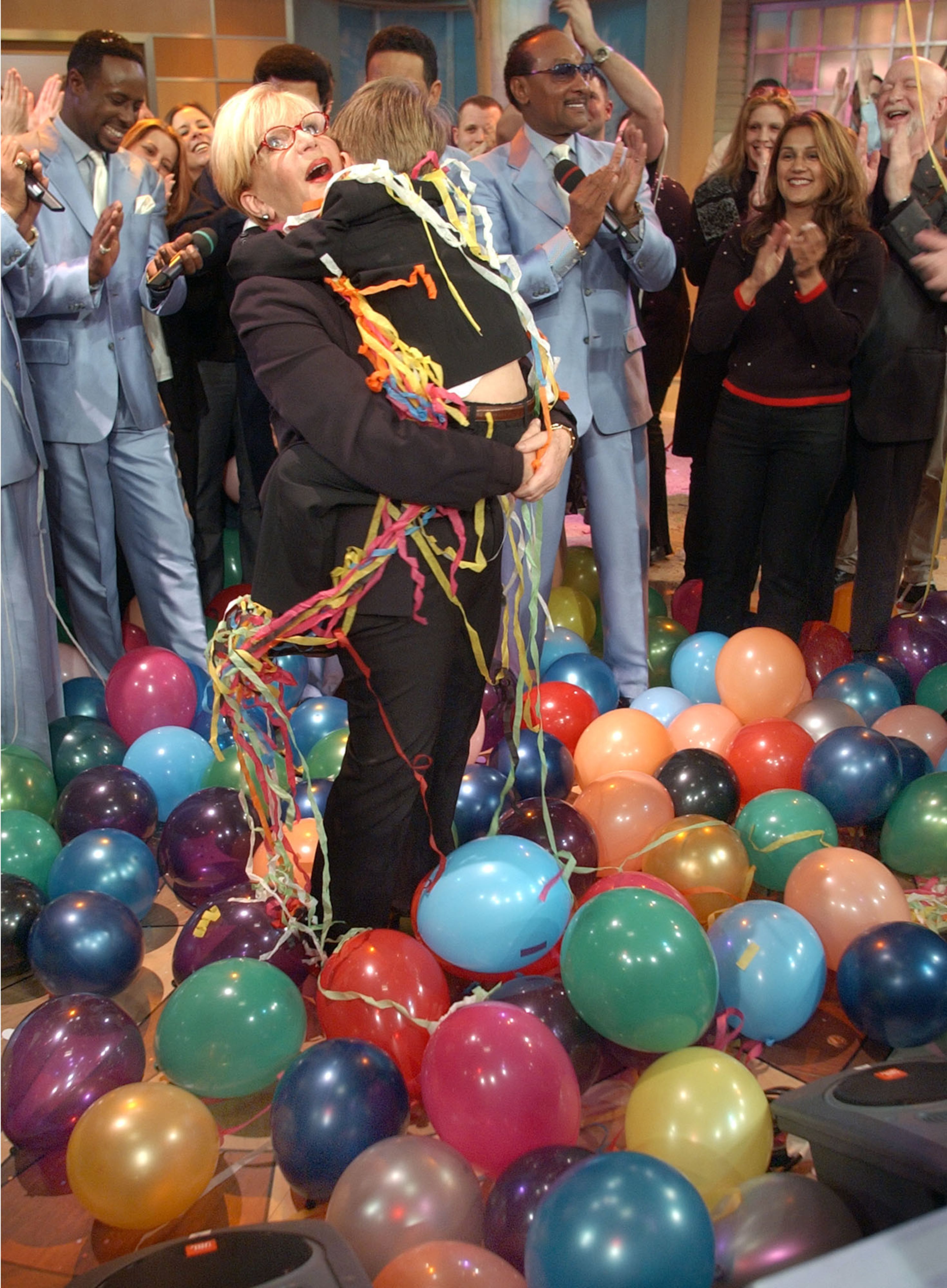 Sally Jessy Raphael, whose daytime talk show is the longest-running of its genre, is hugged by Max Romanoff, her six-year-old grandson, during the taping of her last show, in New York, Wednesday April 24, 2002. Raphael, a 59-year-old former disc jockey, began the show as a local St. Louis program in 1983, and went national the next year. The final show will air in May. (AP Photo/Richard Drew)