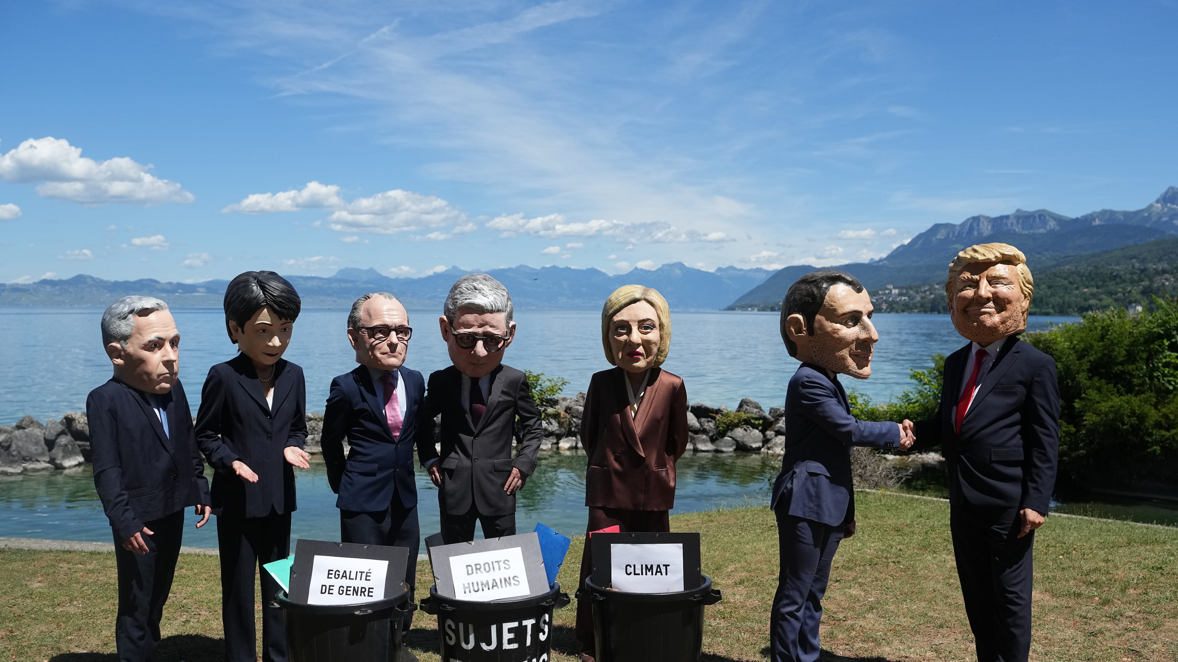 Oxfam's satirical 'big heads' of the G7 leaders pose, in Evian-les-Bains, France, Sunday, June 14, 2026, ahead of the G7 summit scheduled to take place in France June 15-17. (AP Photo/Thibault Camus)