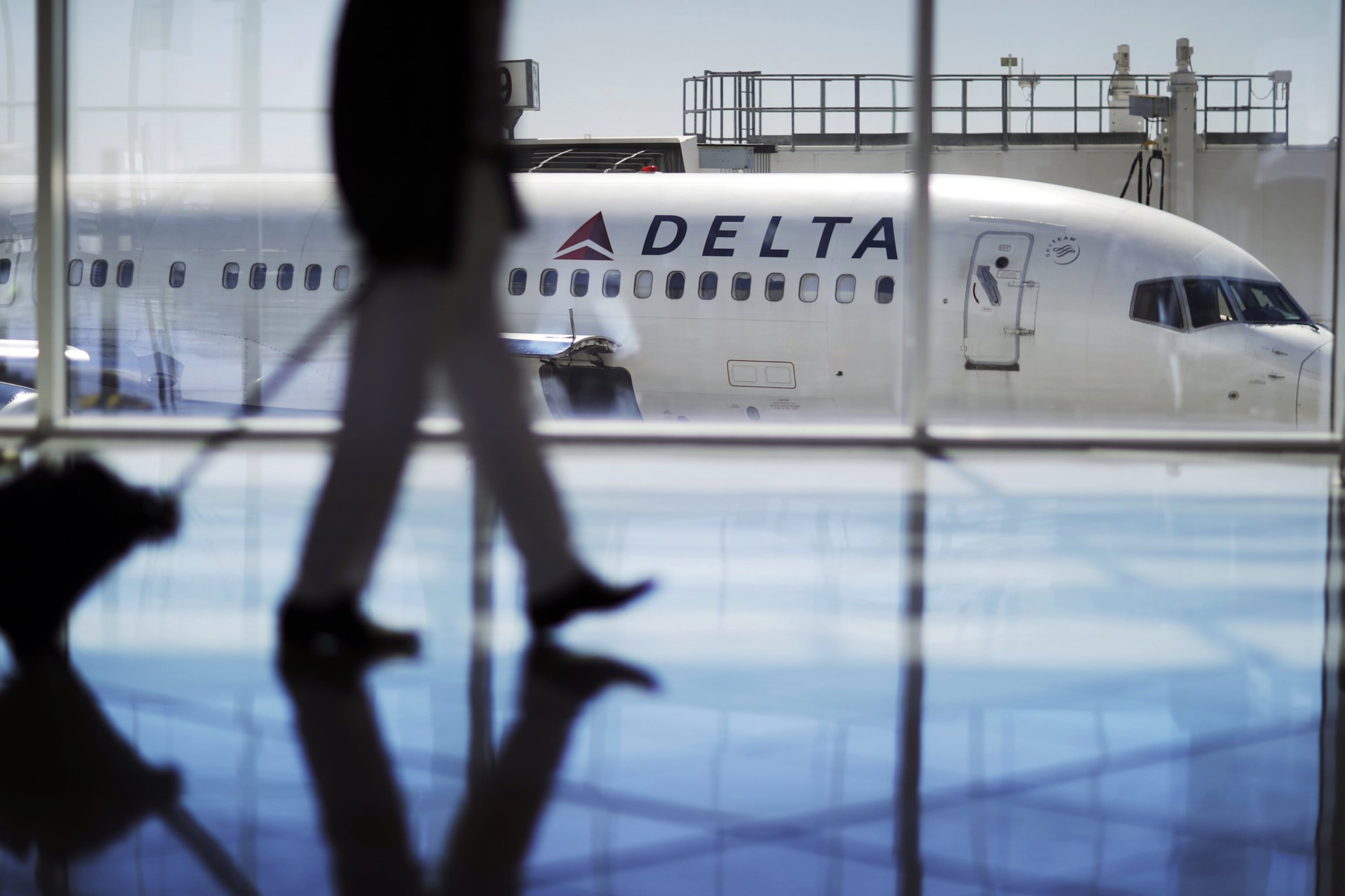 In this Oct. 13, 2016, file photo, a Delta Air Lines jet sits at a gate at Hartsfield-Jackson Atlanta International Airport. (David Goldman/AP File)