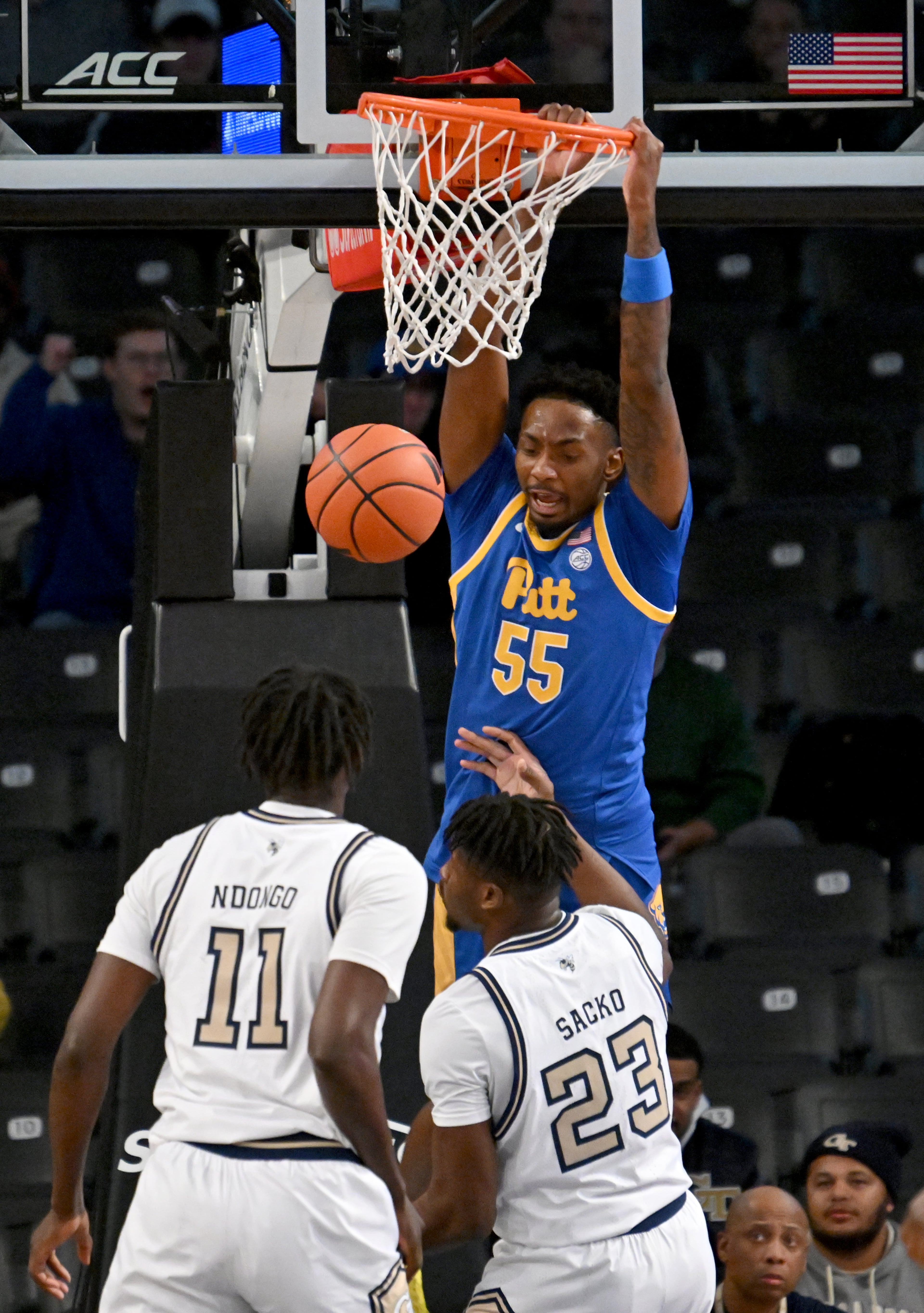 Pittsburgh forward Zack Austin (55) hangs on the basket after dunking the ball during the first half of an NCAA college basketball game at Georgia Tech’s McCamish Pavilion, Tuesday, January 23, 2024, in Atlanta. (Hyosub Shin / Hyosub.Shin@ajc.com)