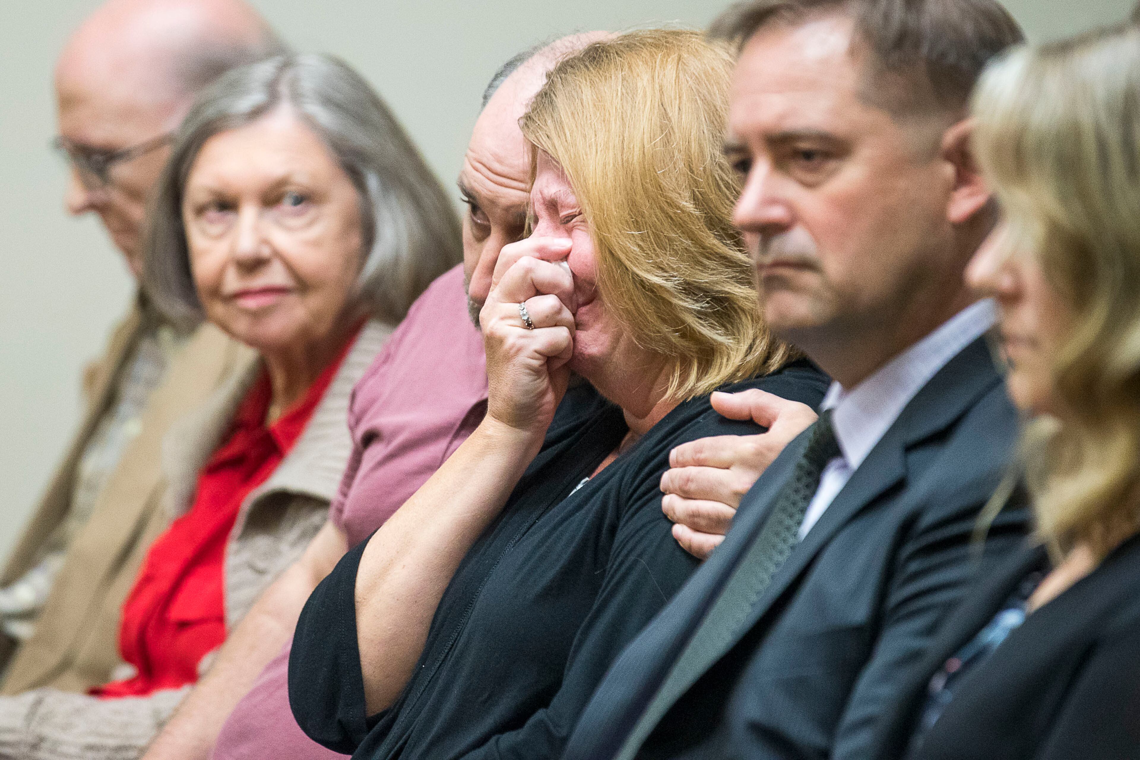 10/14/2019 -- Decatur, Georgia -- Kathy Olsen, wife of Robert "Chip" Olsen, is consoled as the verdict for her husband's trial is read in front of DeKalb County Superior Court Judge LaTisha Dear Jackson at the DeKalb County Courthouse in Decatur, Monday, October 14, 2019. (Alyssa Pointer/Atlanta Journal Constitution)