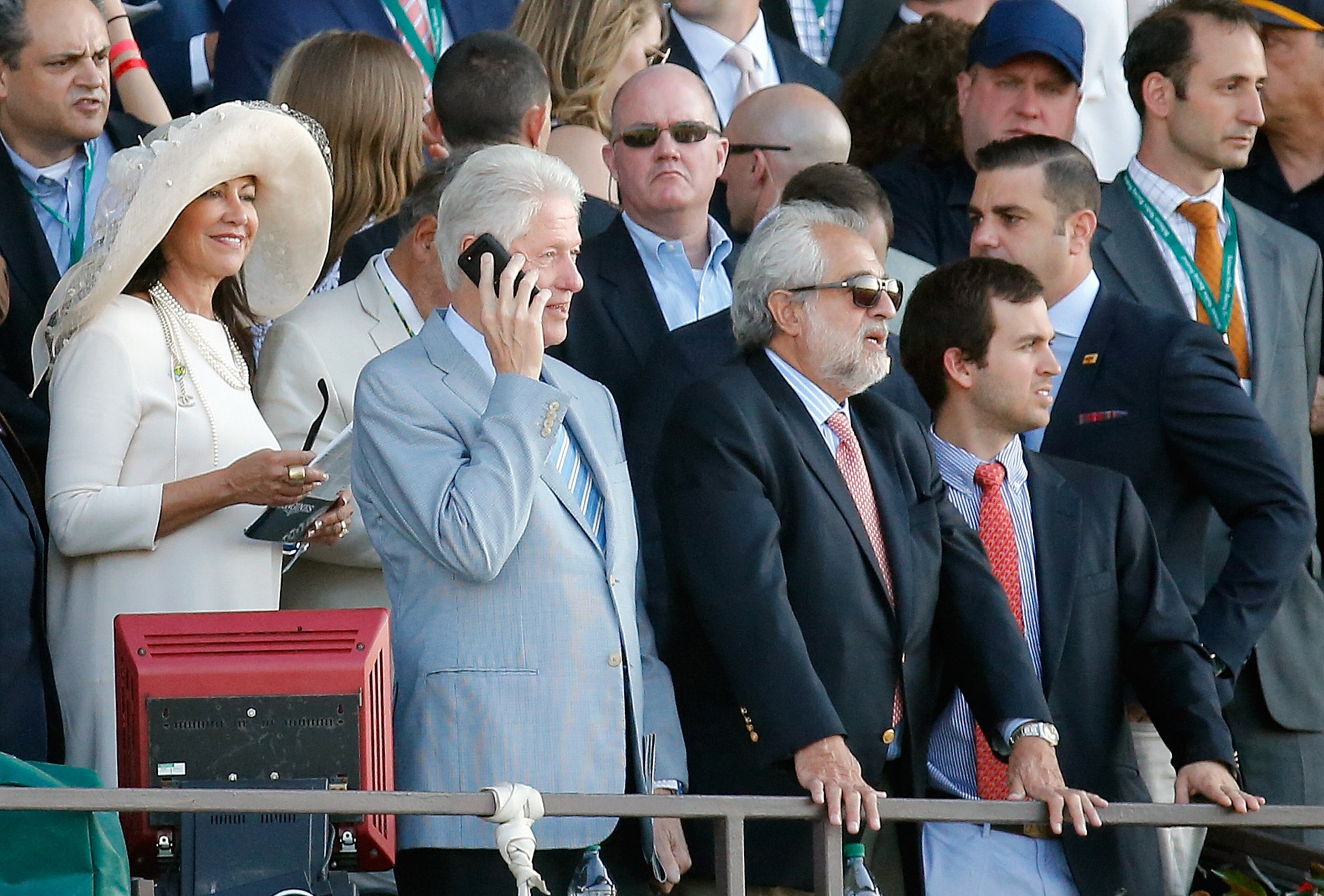 ELMONT, NY - JUNE 06: Former U.S. President Bill Clinton talks on his phone during the 147th running of the Belmont Stakes at Belmont Park on June 6, 2015 in Elmont, New York. (Photo by Rob Carr/Getty Images)