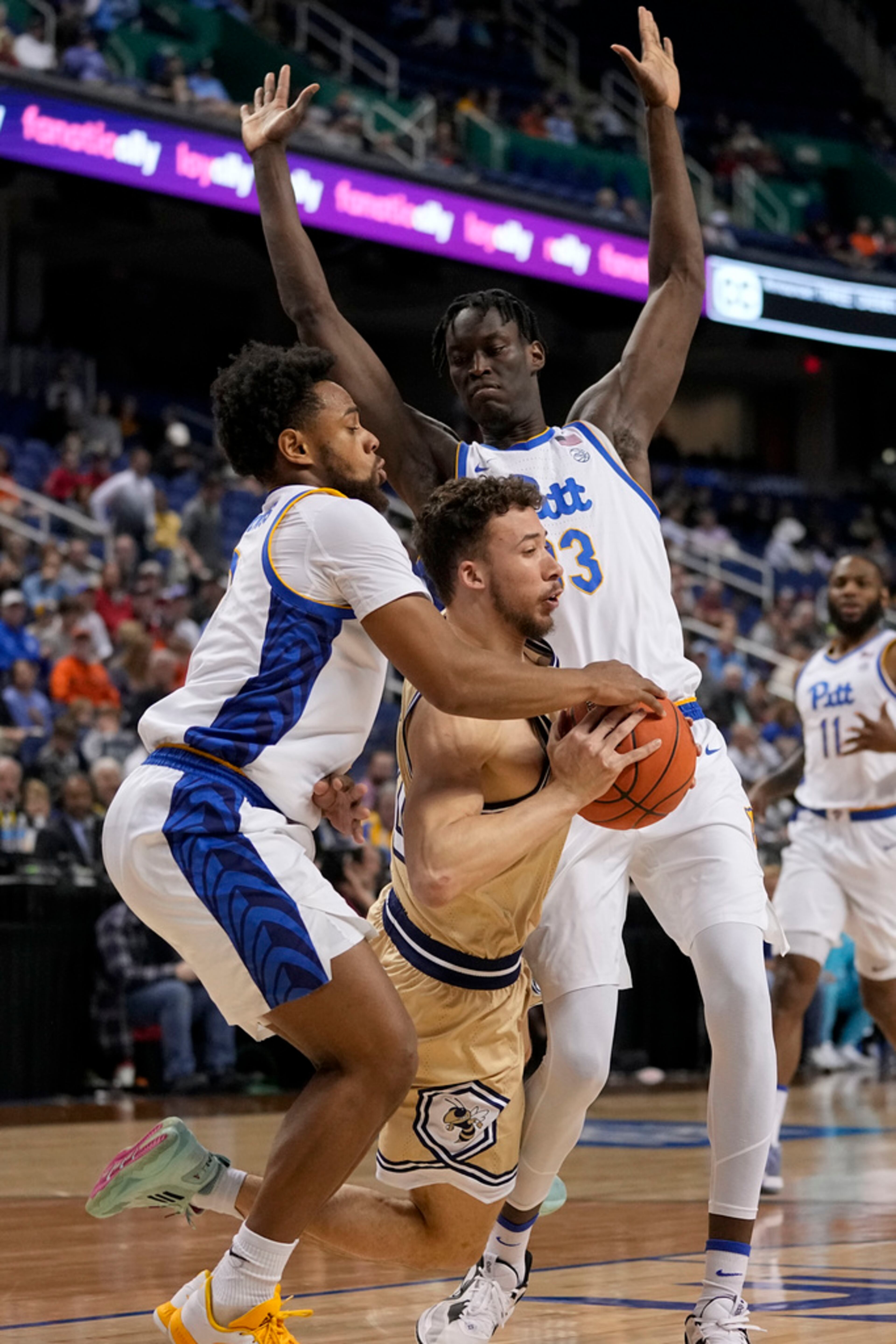 Georgia Tech guard Lance Terry drives between Pittsburgh guard Nelly Cummings and center Federiko Federiko during the first half of an NCAA college basketball game at the Atlantic Coast Conference Tournament, Wednesday, March 8, 2023, in Greensboro, N.C. (AP Photo/Chris Carlson)