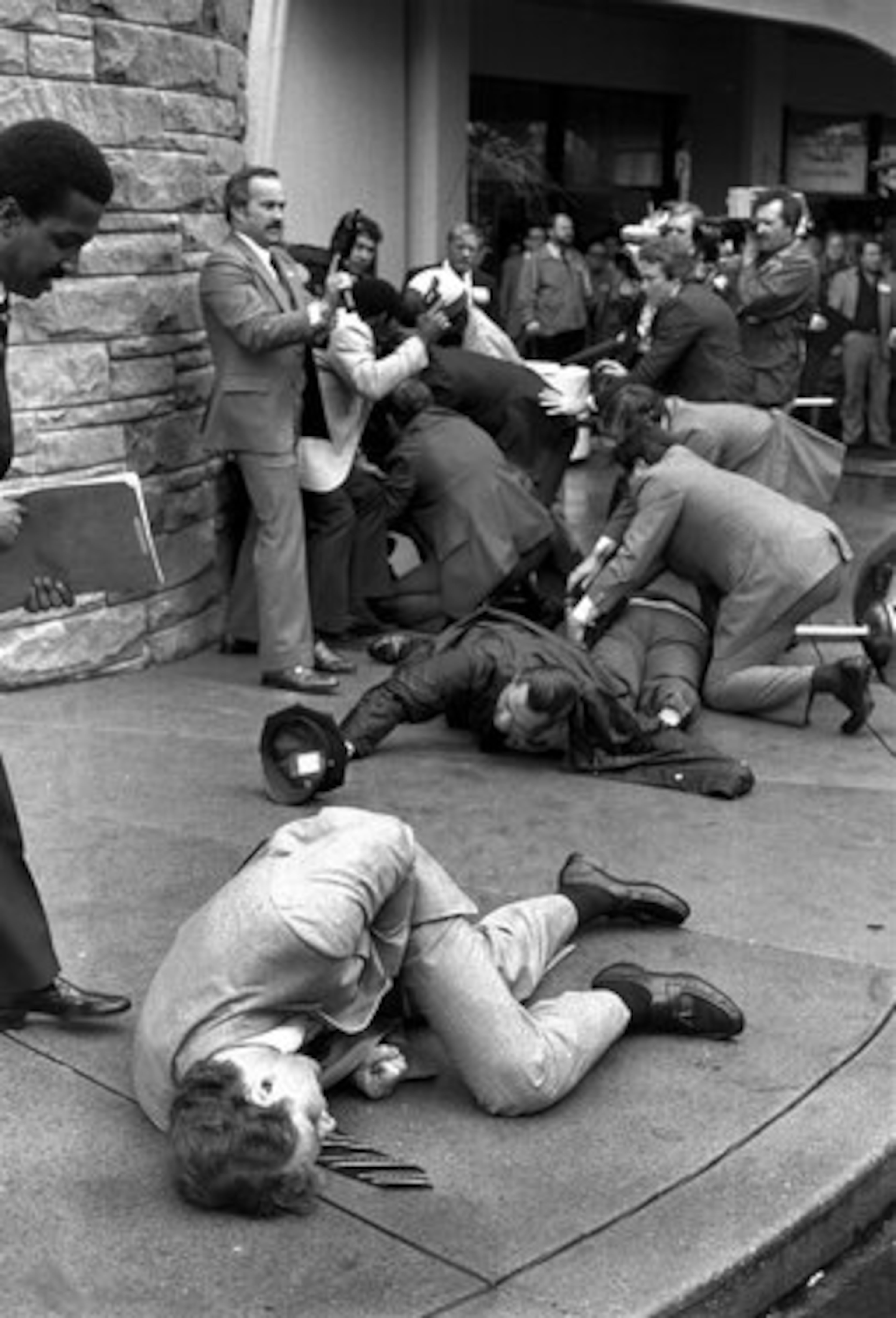 FILE - Secret Service agent Timothy J. McCarthy, foreground, Washington police officer, Thomas K. Delehanty, center, and presidential Press Secretary, James Brady, background, lie wounded on a street outside a Washington hotel after shots were fired at U.S. President Reagan on March 30, 1981. Thirty years later McCarthy, who threw himself into the line of fire taking a bullet intended for President Reagan, is now a police chief in a Chicago suburb.