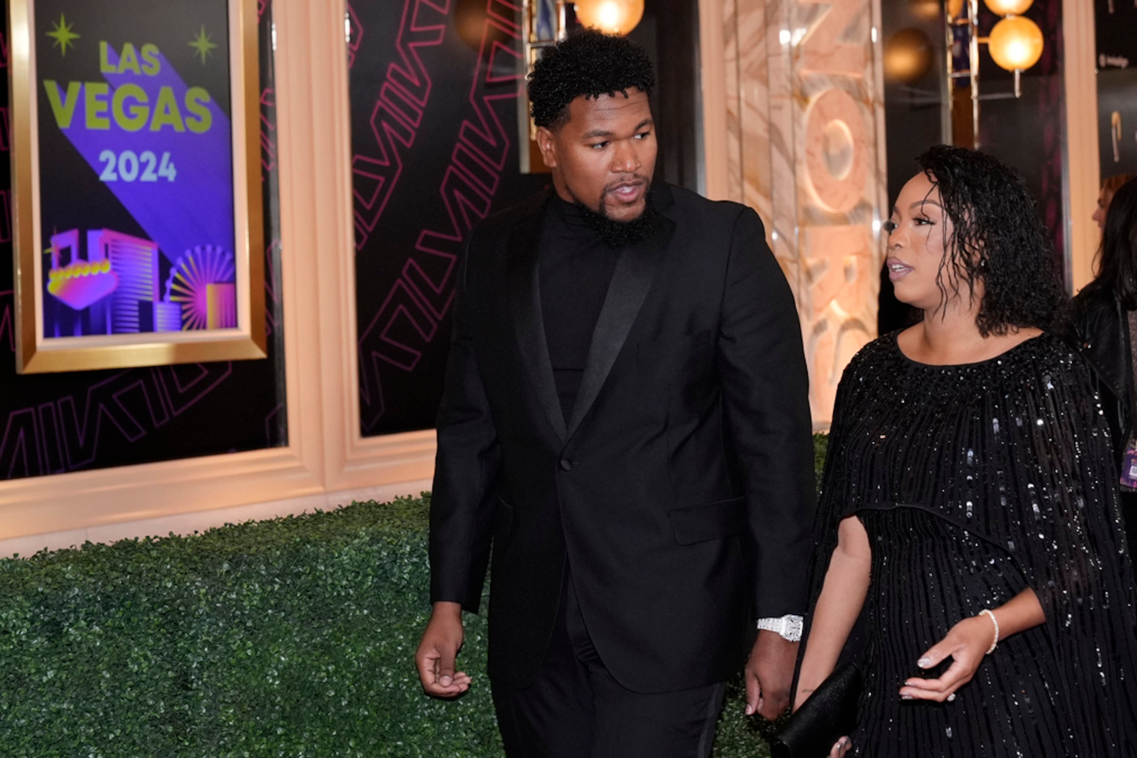 Dawuane Smoot of the Jacksonville Jaguars, left, walks on the red carpet at the NFL Honors award show ahead of the Super Bowl 58 football game Thursday, Feb. 8, 2024, in Las Vegas. The San Francisco 49ers face the Kansas City Chiefs in Super Bowl 58 on Sunday. (AP Photo/Godofredo A. Vásquez)