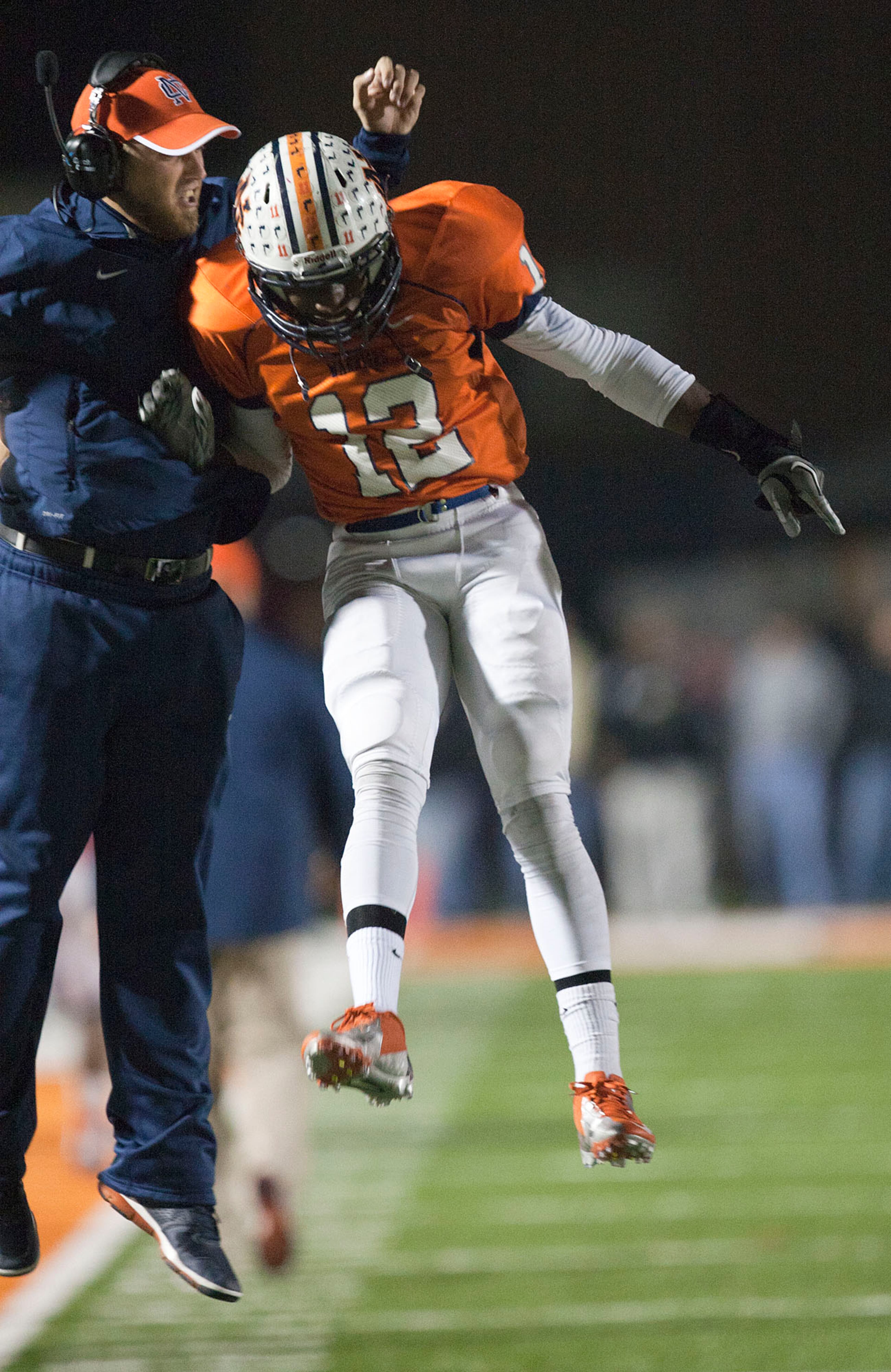 North Cobb Assistant Coach Ryan Thackston celebrates with Warrior receiver Xavier Borishade after a second half touchdown against Mill Creek Friday, Nov. 30, 2012. KELLY J. HUFF/SPECIAL