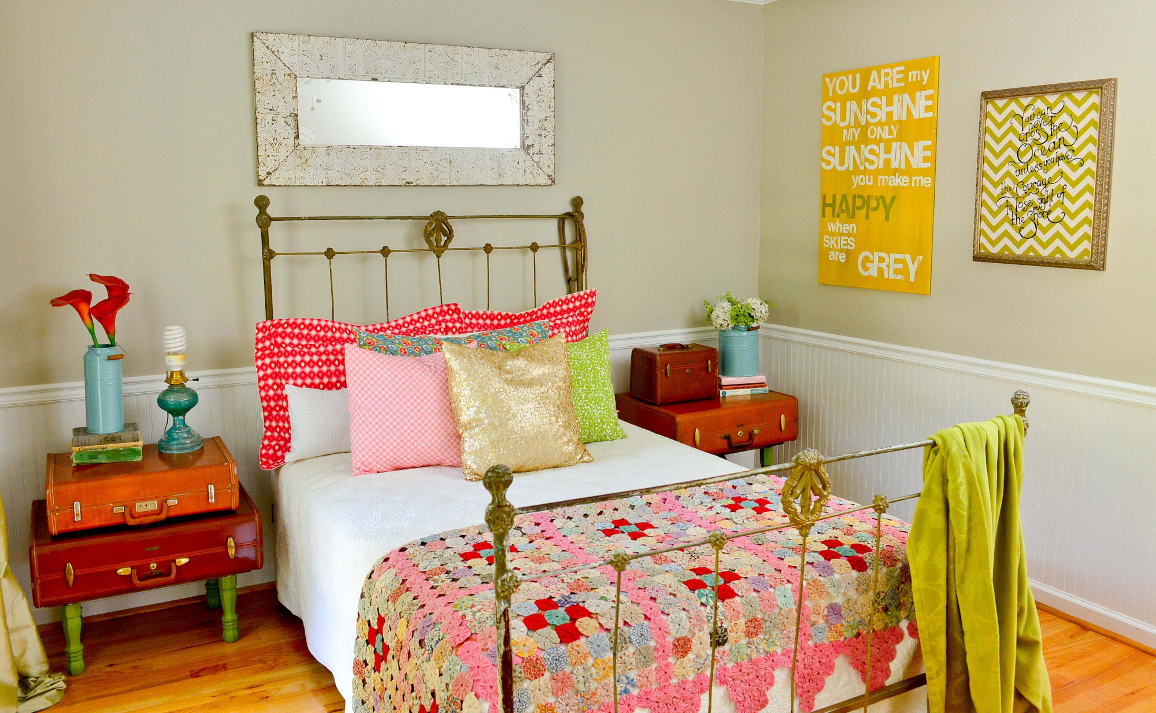Guest bedroom: DIY projects abound in Dena Stormer's home, including the guest bedrooms. The luggage nightstands and pillows are all her creations. Then she's brought in inherited items, such as the bed, coverlet, quilt and teal lamp.