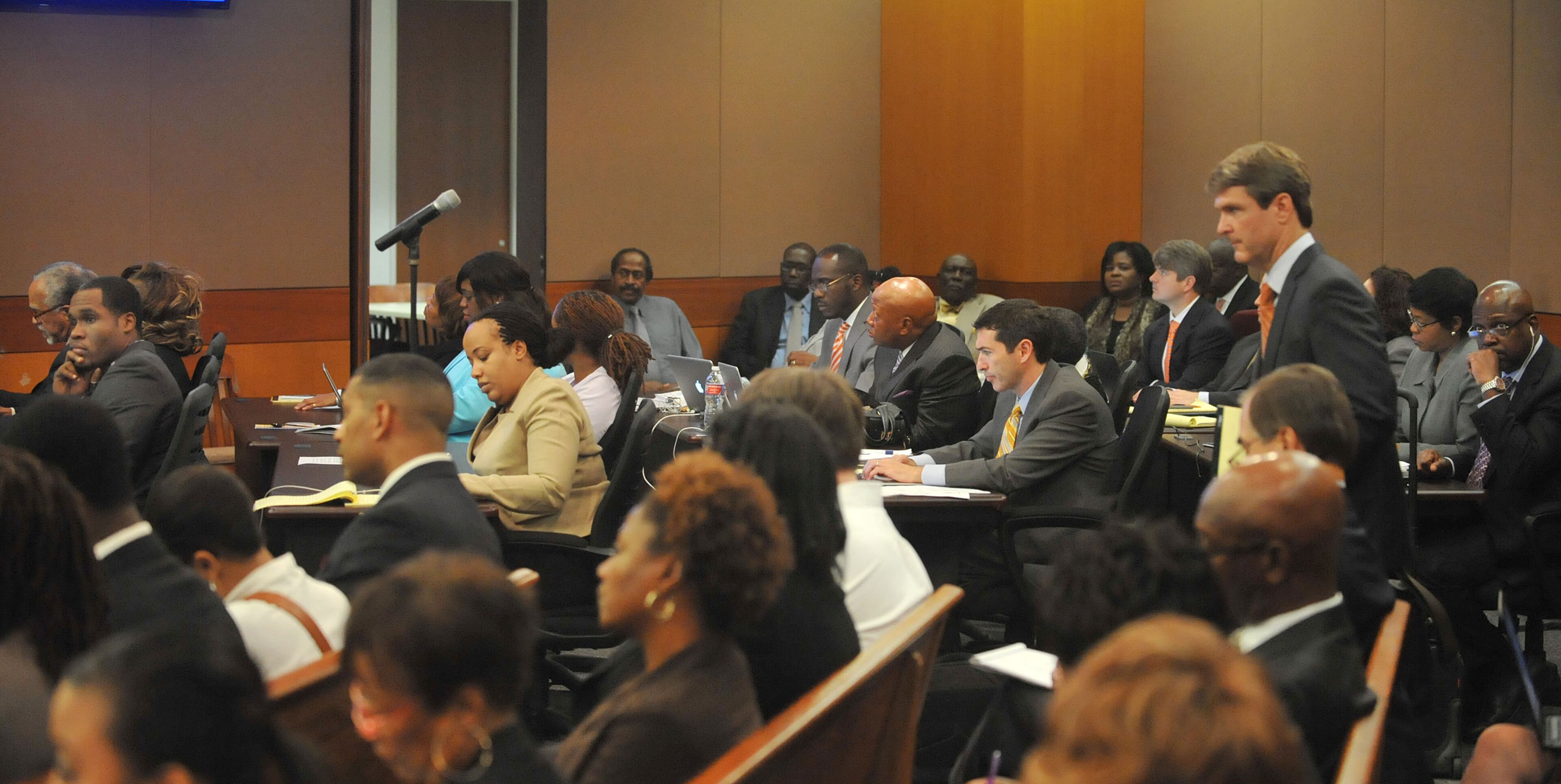 Defendants and their attorneys listen during the prosecution's opening statement Monday morning. The prosecution lays out its case during an expected three-hour-long opening statement to kick off the Atlanta Public Schools test-cheating trial before Judge Jerry Baxter in Fulton County Superior Court, Monday September 29, 2014. Not all 12 defense lawyers will be making opening statements; some are planning to reserve theirs until after the prosecution presents its case. KENT D. JOHNSON / KDJOHNSON@AJC.COM