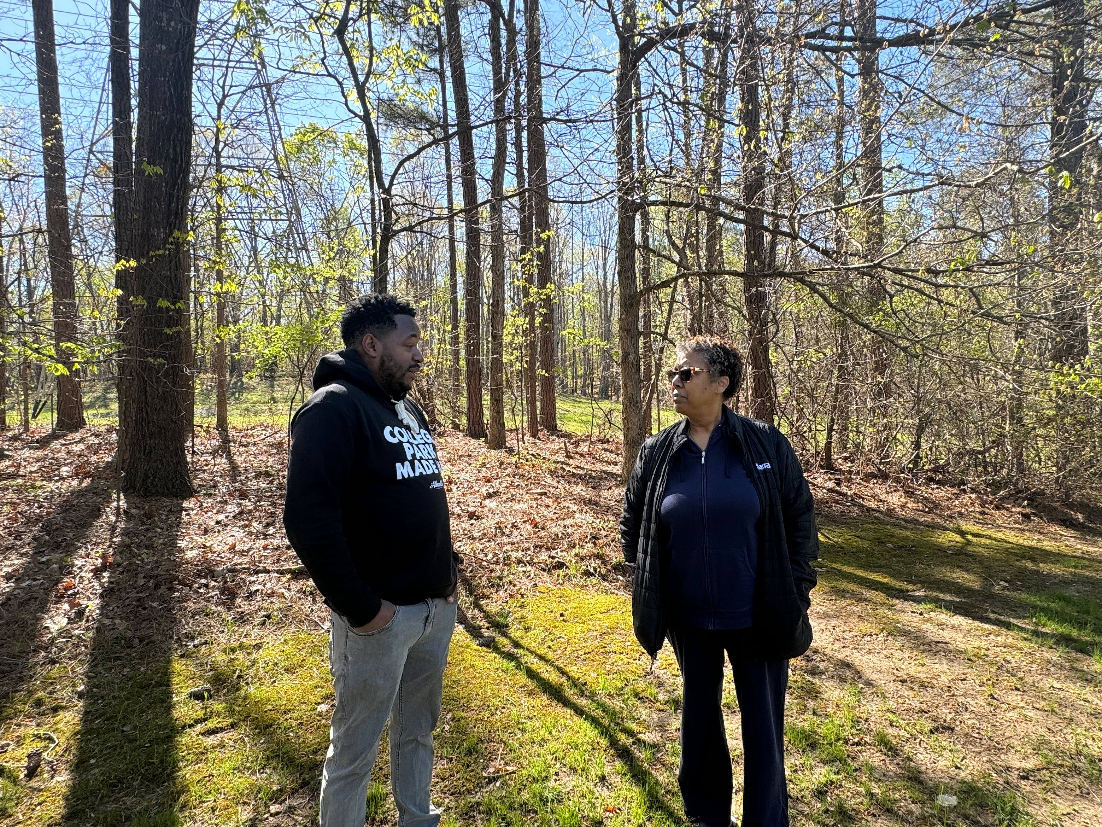 College Park resident Mose James IV is in the backyard of Carmen Miller's property. Her land is steps from where NextEra plans to build a battery storage facility on the 62-acre site. (Adrianne Murchison)