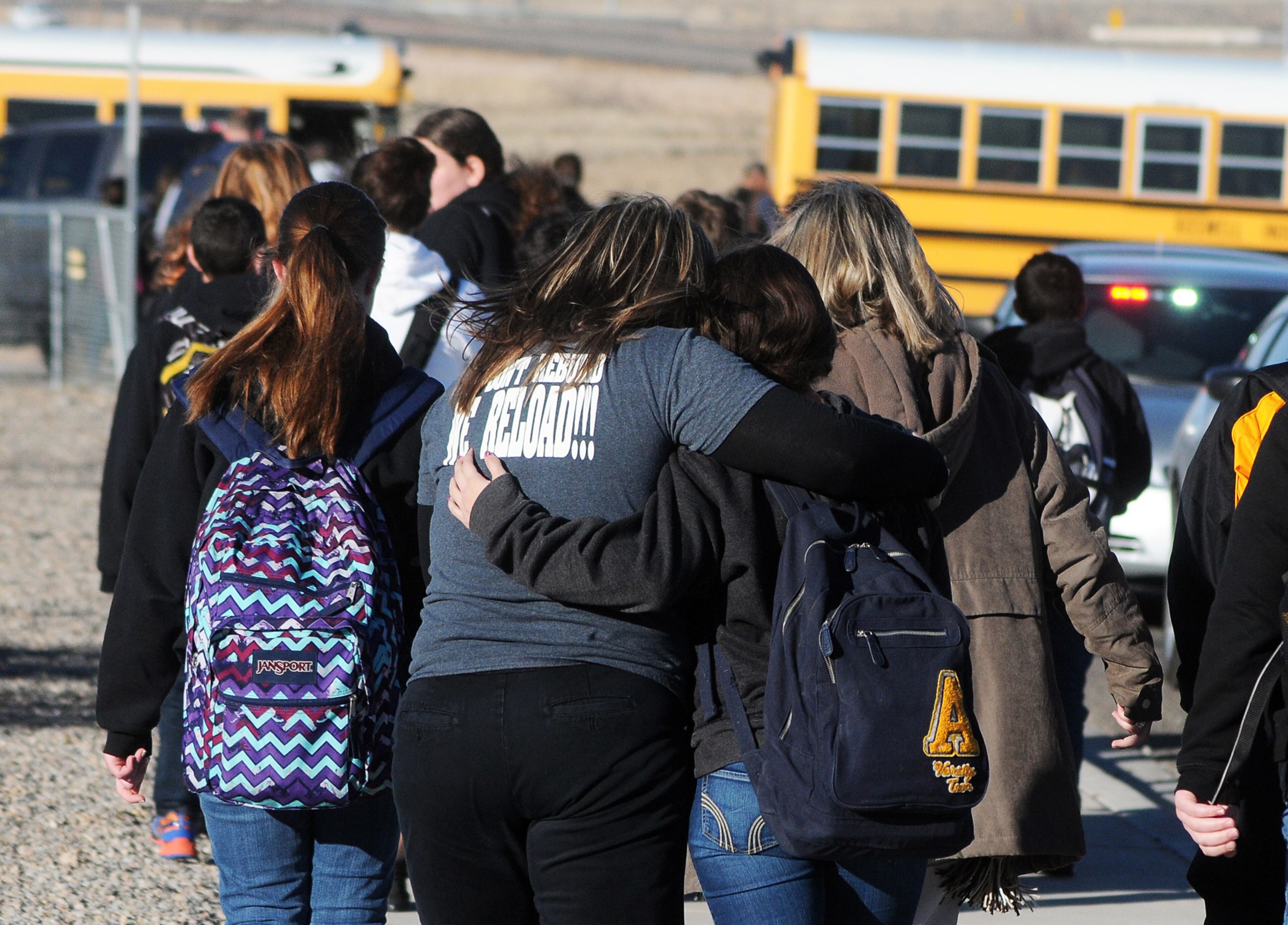 Students are escorted from Berrendo Middle School after a shooting incident on Jan. 14, 2014, in Roswell, N.M. Roswell police said the suspected shooter was arrested at the school.