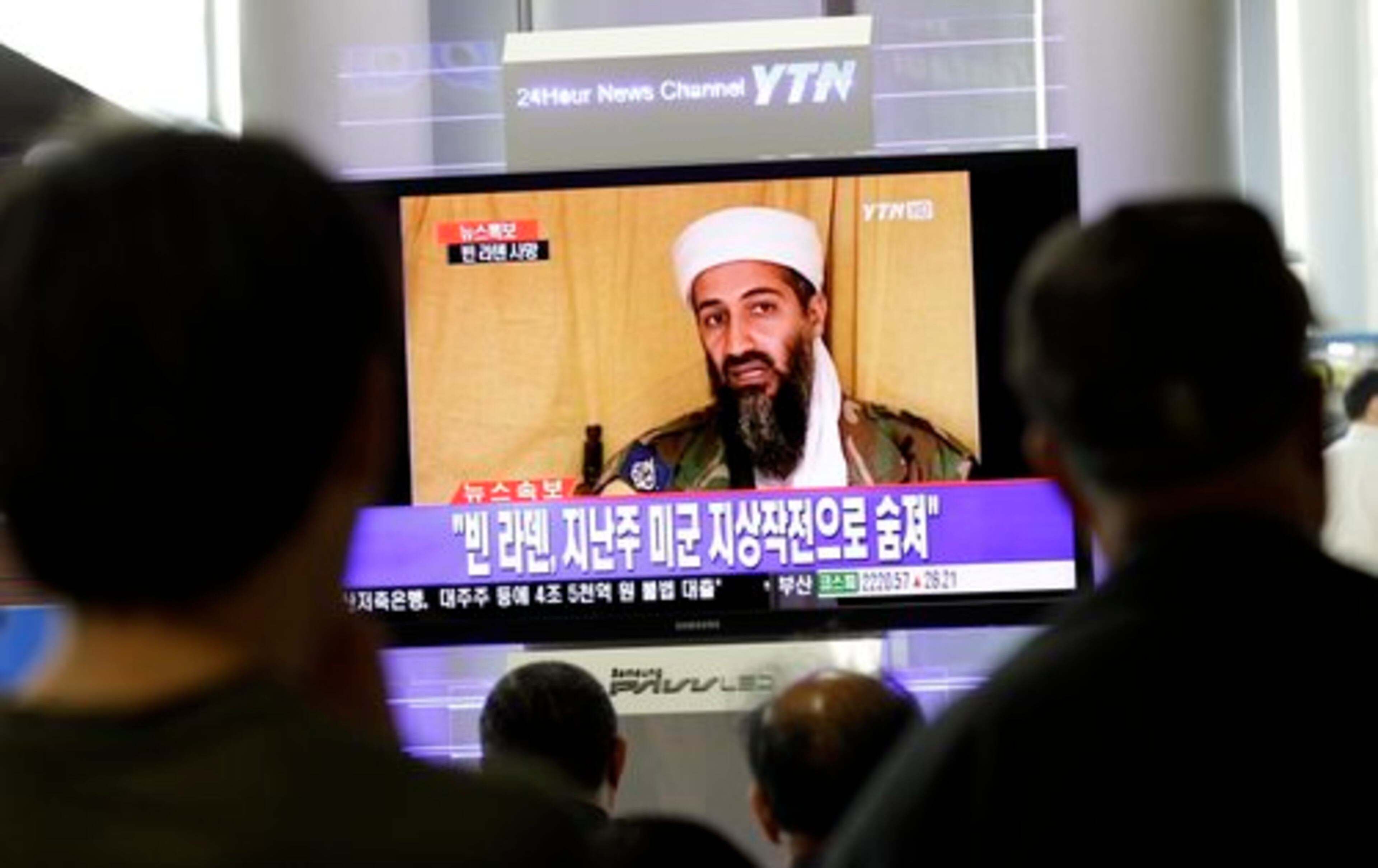 South Koreans watch a TV broadcasting a report about Osama bin Laden, at Seoul train station in Seoul, South Korea, Monday, May 2, 2011. Bin Laden, the glowering mastermind behind the Sept. 11, 2001, terror attacks that murdered thousands of Americans, was killed in an operation led by the United States, President Barack Obama said Sunday. The Korean read "Bin Laden, killed in an operation led by the United States."