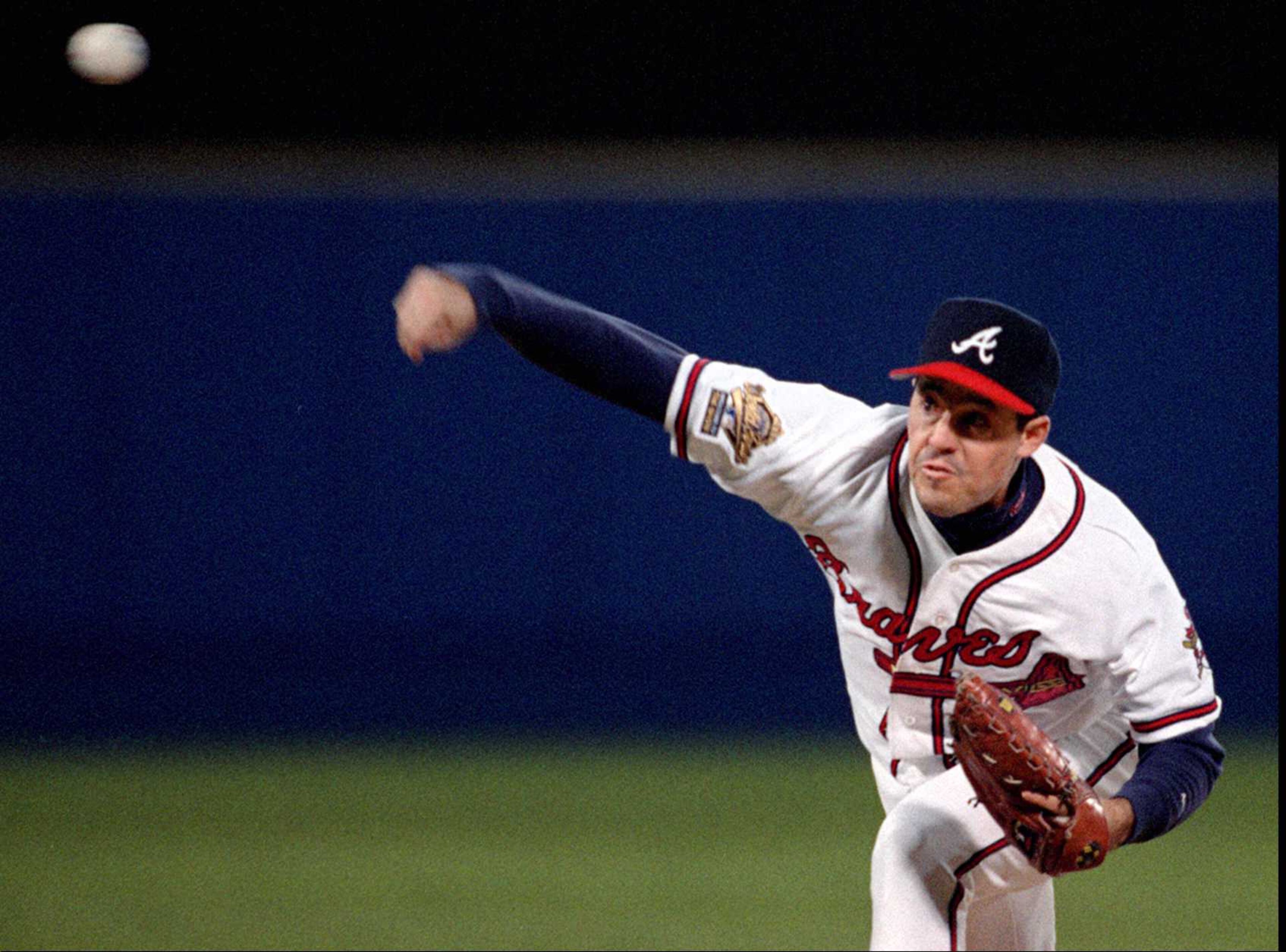Greg Maddux pitches in game 1 of the World Series.