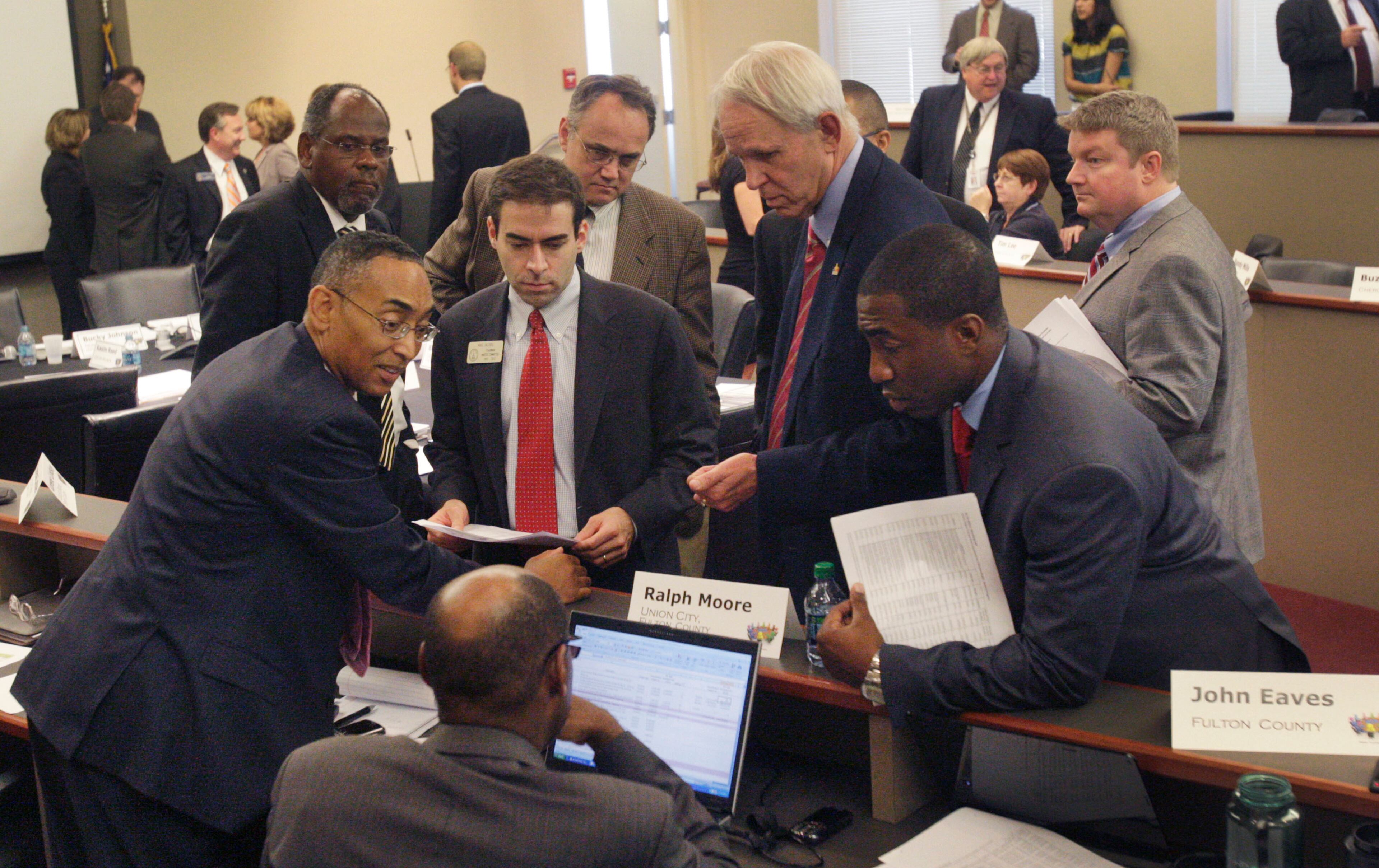DeKalb County Chief Executive Officer Burrell Ellis (far left) meets with other roundtable members to caucus as the full Atlanta Regional Transportation Roundtable meets on Monday, Aug. 15, 2011. The executive committee met and approved a draft list hours later. Bob Andres/bandres@ajc.com