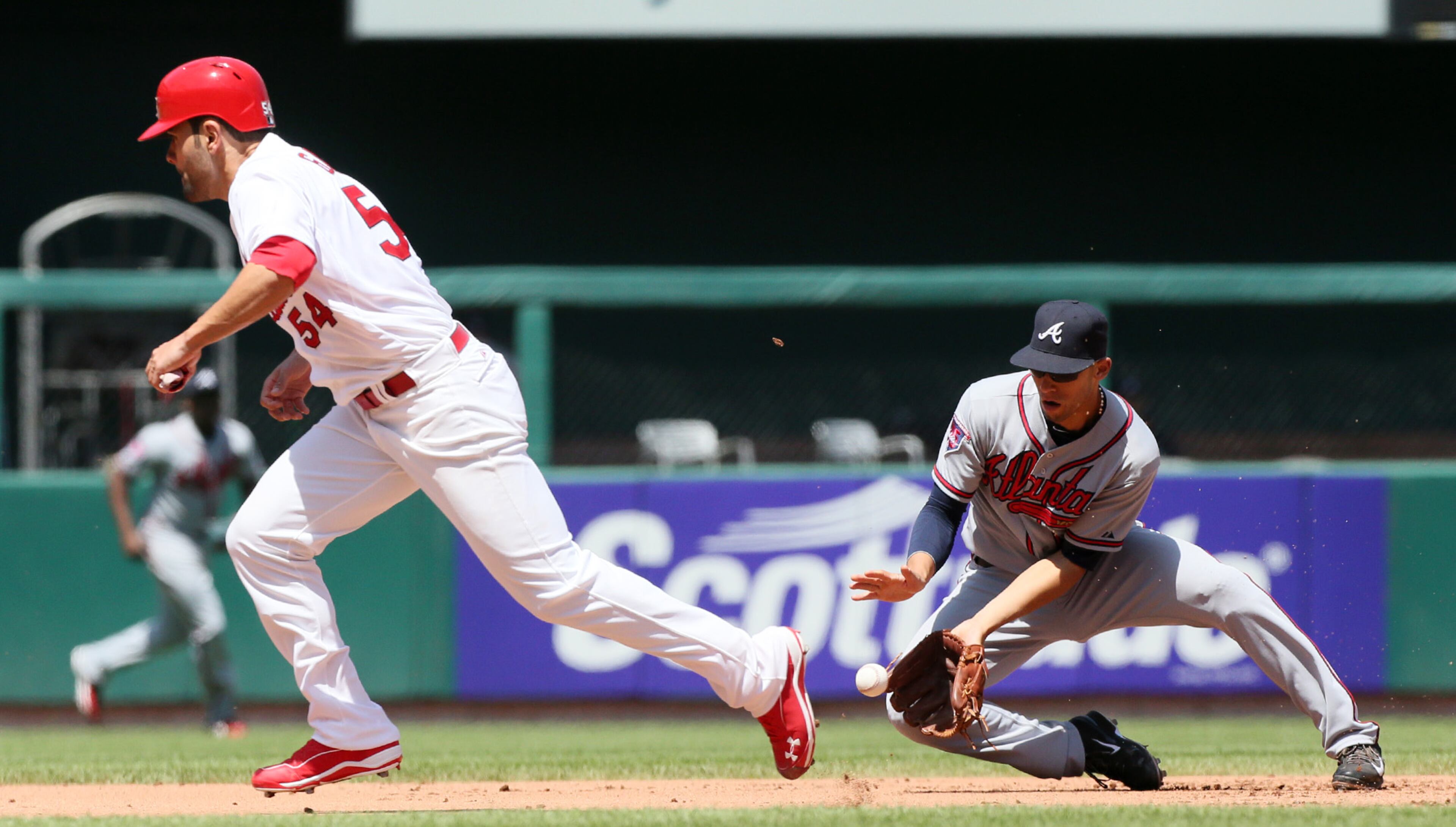St. Louis Cardinals' Jaime Garcia tries to advance from second to third as Atlanta Braves shortstop Andrelton Simmons fields Cardinals' Kolten Wong's double play ball in the fourth inning action of a baseball game Sunday, May 17, 2014, at Busch Stadium in St. Louis. (AP Photo/The Post-Dispatch, Chris Lee)