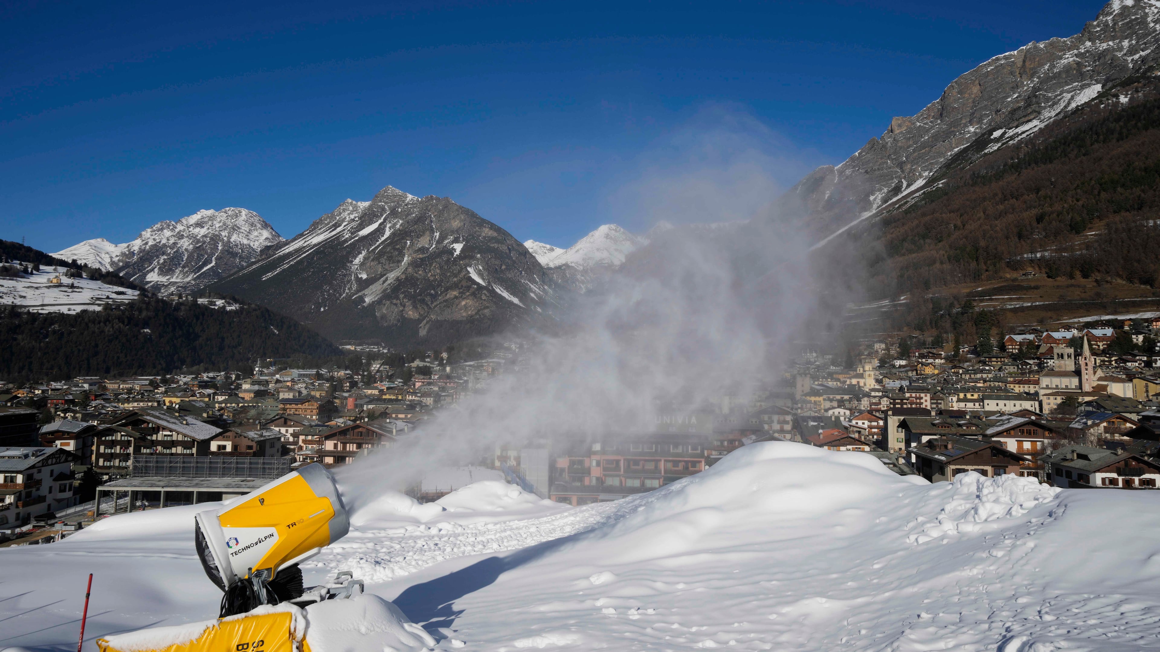 FILE - A snow gun sprays artificial snow at the Stelvio Ski Center, venue for the alpine ski and ski mountaineering disciplines at the 2026 Milan Cortina Winter Olympics, in Bormio, Italy, Jan. 16, 2025. (AP Photo/Luca Bruno, File)