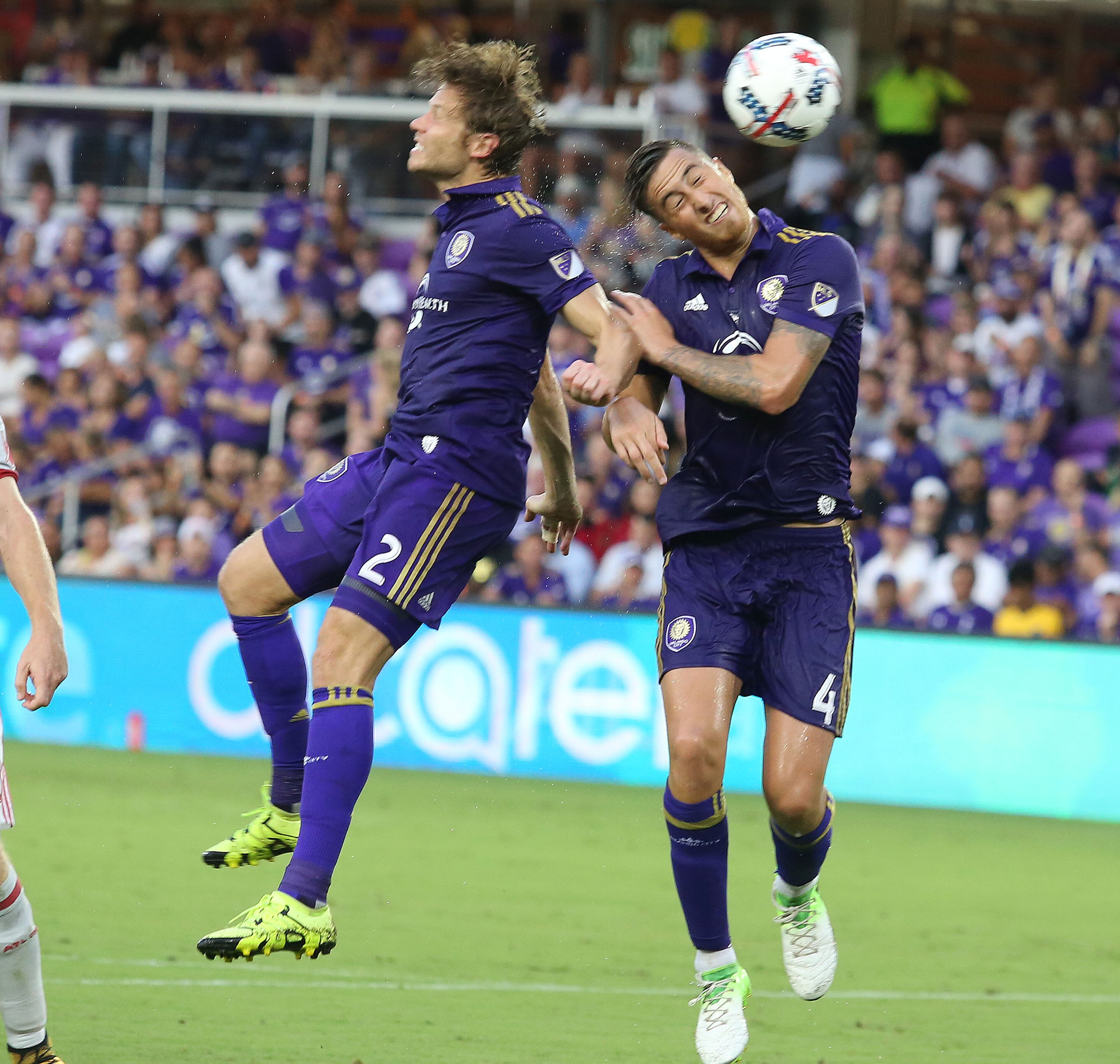 Orlando City's Jose Aja (4) heads the ball beside teammate Jonathan Spector (2) during action against Atlanta United at Orlando City Stadium on Friday, July 21, 2017, in Orlando, Fla. (Stephen M. Dowell/Orlando Sentinel/TNS)