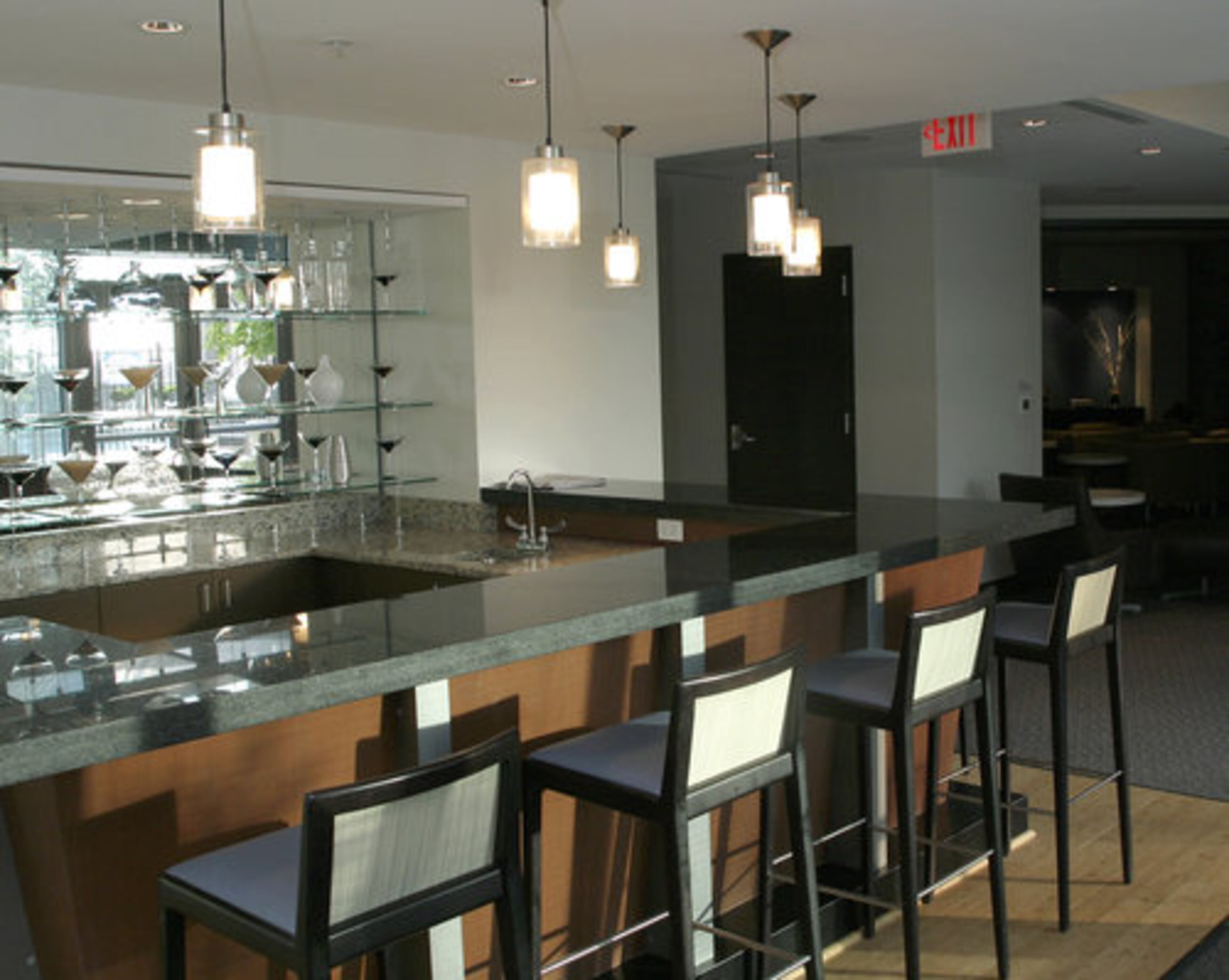 The clubroom for residences at Twelve Centennial Park offers a spacious bar, TV lounge and media center.